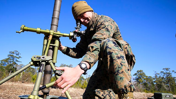 Lance Cpl. Richard Marsh, a mortarman with 2nd Battalion, 2nd Marine Regiment, and a Jacksonville, Fla. native, adjusts his weapon in order to sight in on a specific target during a gun drill at training area G-G aboard Camp Lejeune, N.C., Feb. 18, 2015. Marines can fire the mortar from a mount (as depicted) or in hand-held mode, making the weapon easily transportable. (U.S. Marine Corps photo by Cpl. Kirstin Merrimarahajara/released)