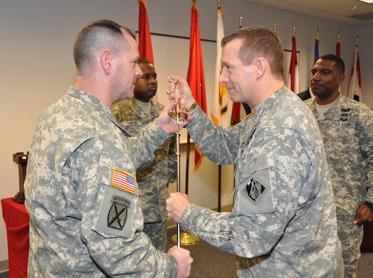 WINCHESTER, Va. - Brig. Gen. Robert Carlson, acting Transatlantic Division commander passes the ceremonial sword to Command Sgt. Maj. Ronald Johnson, incoming Transatlantic Division command sergeant major during a Change of Responsibility Ceremony.
