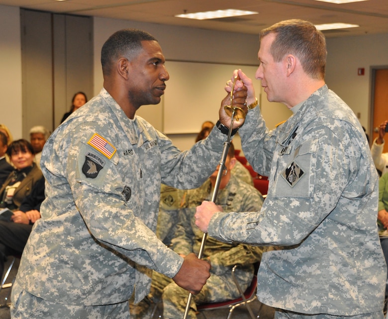 WINCHESTER, Va. - Command Sgt. Maj. Roy Ward passes the ceremonial sword to Brig. Gen. Robert Carlson, acting Transatlantic Division commander, during a Change of Responsibility Ceremony. Ward was the first division command sergeant major within the U.S. Army Corps of Engineers.