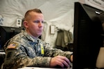 Master Sgt. David Henzler of the 404th Maneuver Enhancement Brigade mans the Protections stations during the 2015 Warfighter training exercise. The 404th MEB recently took part in the 2015 Warfighter Exercise at Camp Atterbury, Indiana. Warfighter is a two-week strategic exercise including over 3,000 service members from the Army and Air National Guard, Army Reserves, Active Army, and Canadian Forces.