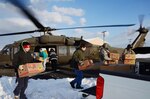 A Virginia Army National Guard aviation crew from the Sandston-based 2nd Battalion, 224th Aviation Regiment delivers food, mail and medicine Feb. 19, 2015, to iced-in Tangier Island, Virginia. The 1.2 square mile island has been iced in since freezing temperatures blanketed the commonwealth last week, making routine seaport deliveries impossible. 