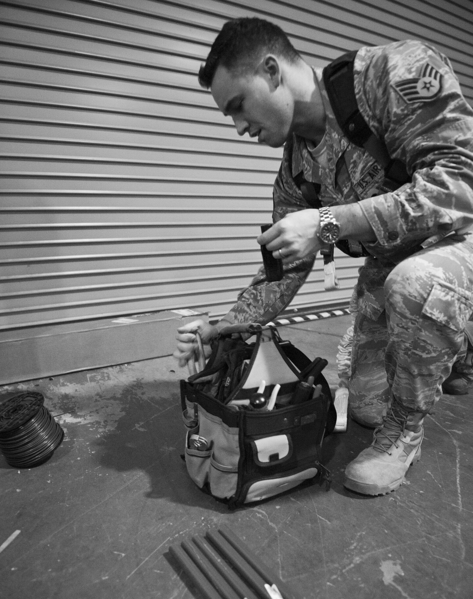 Staff Sgt. Elliot Holloway, 1st Special Operations Civil Engineer Squadron electrical systems craftsman, looks for a tool to cut a conduit on Hurlburt Field, Fla., Feb. 18, 2015. Holloway and his team used several conduits to update a fire system. (U.S. Air Force photo/Senior Airman Krystal M. Garrett)