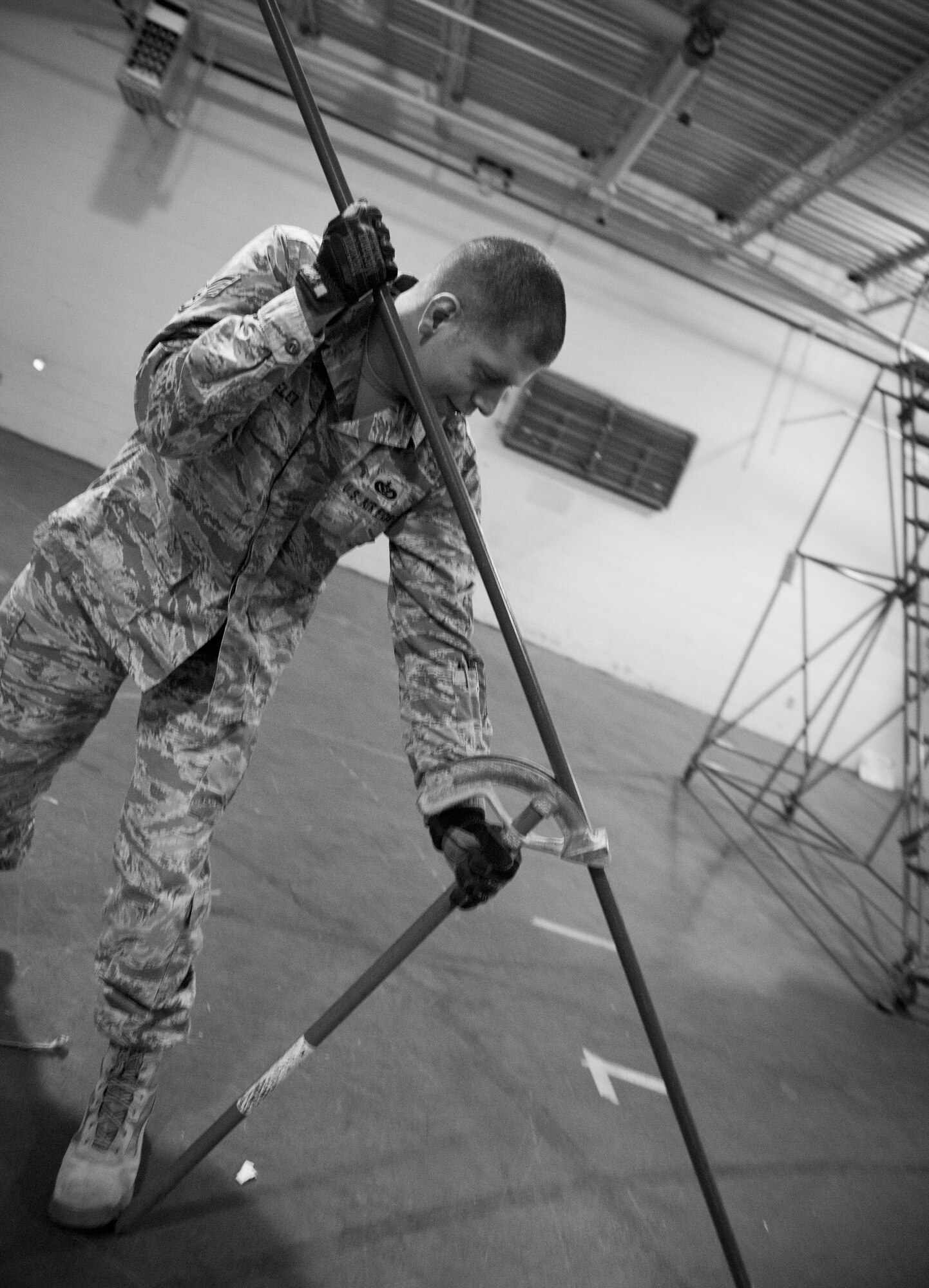 Staff Sgt. Wesley Velez, 1st Special Operations Civil Engineer Squadron electrical systems craftsman, bends a conduit on Hurlburt Field, Fla., Feb. 18, 2015. Some conduits were bent to fit around ceiling fixtures. (U.S. Air Force photo/Senior Airman Krystal M. Garrett)