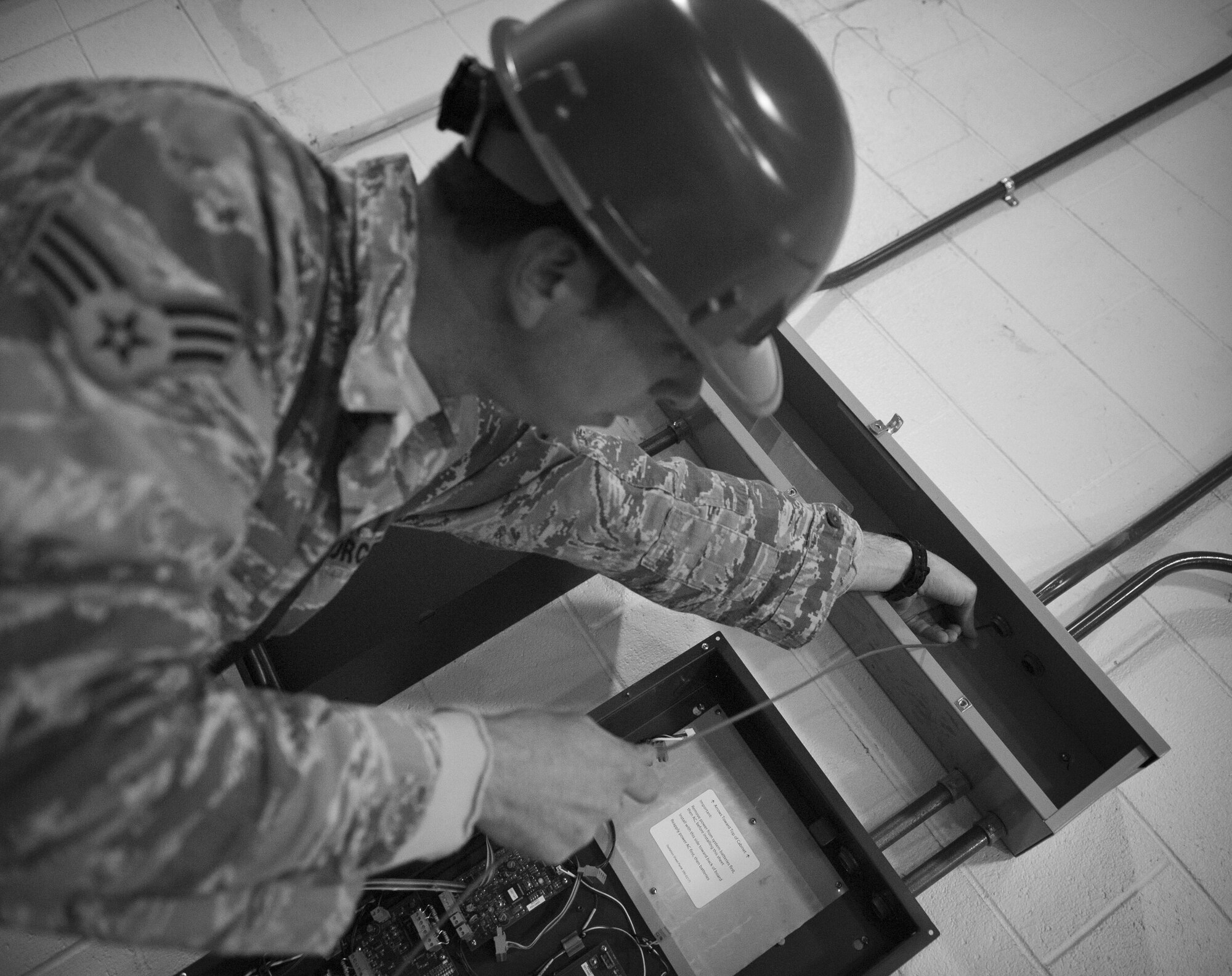Senior Airman Alex Thurner, 1st Special Operations Civil Engineer Squadron electrical systems journeyman, runs wiring through a conduit on Hurlburt Field, Fla., Feb. 18, 2015. The life safety section installs and maintains fire suppression and alarm systems for every building on base. (U.S. Air Force photo/Senior Airman Krystal M. Garrett)