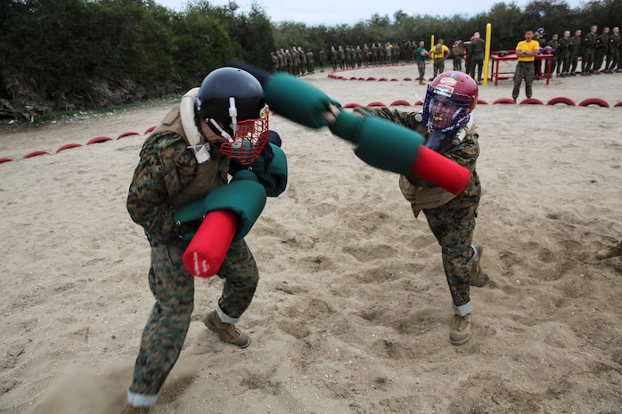 Recruits from Hotel Company, 2nd Recruit Training Battalion, fight each other during a pugil stick bout at Marine Corps Recruit San Diego, Jan. 28. Once in the arena, the fighters were checked by the Marine Corps Martial Arts Instructor or a drill instructor to ensure their gear was properly worn before their bout began.