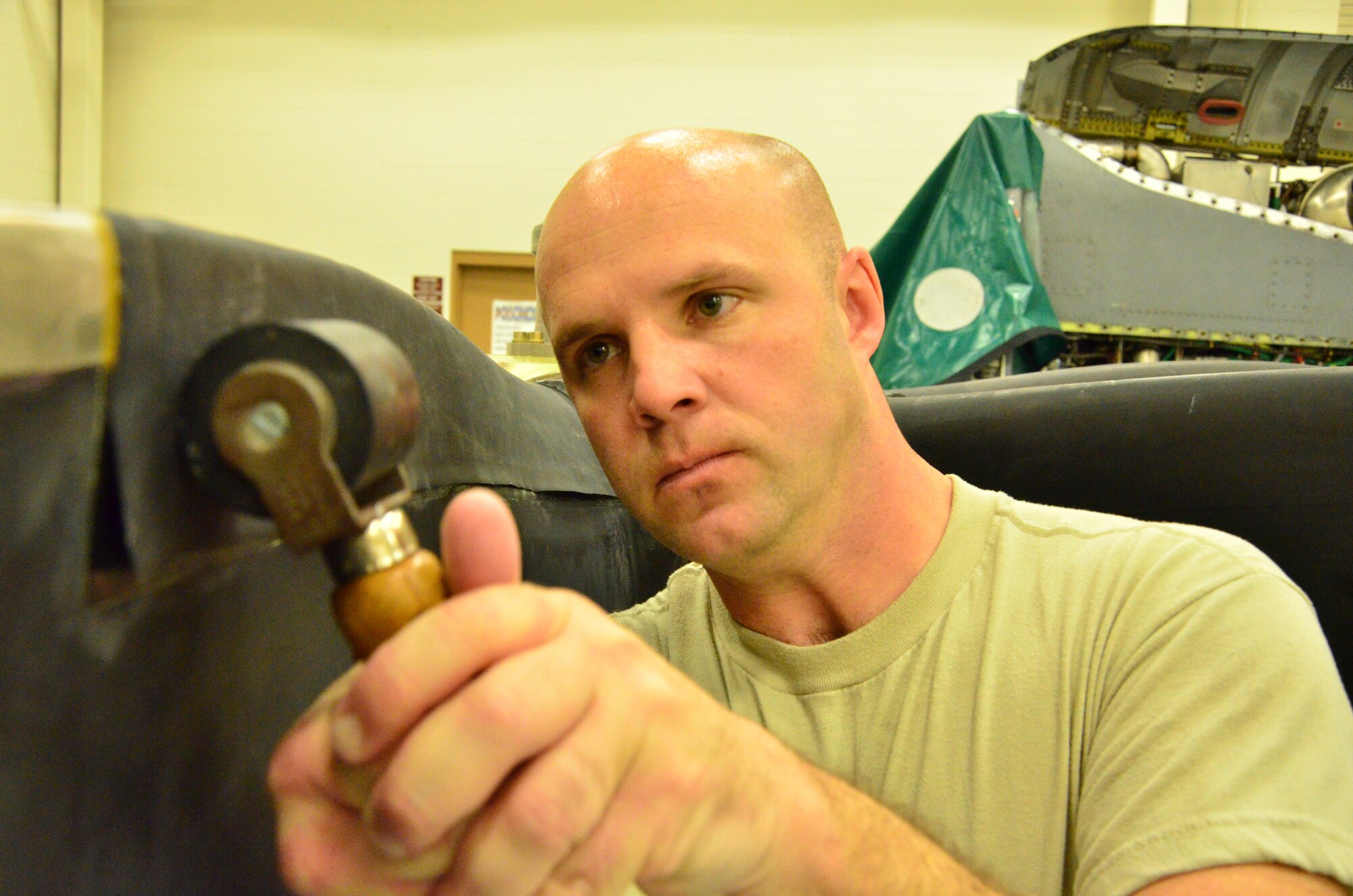 Step Four: Tech Sgt. Ronnie Graham, a turboprop craftsman with the 403rd Maintenance Squadron, rolls out any creases or bubbles in the rubber sleeve after attaching it to a C-130Jpropeller 11 Feb in the Roberts Consolidated Maintenance Facility at Keesler Air Force Base. The  rubber sleeve fits onto the leading edge of a propeller of a C-130J aircraft and provides protection and anti icing capabilities. (U.S. Air Force Photo/Master Sgt. Brian Lamar)