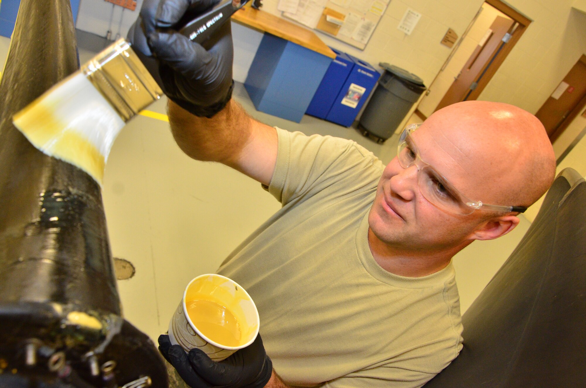 Step Two: Tech Sgt. Ronnie Graham, a turboprop craftsman with the 403rd Maintenance Squadron, applies a specialized adhesive to the propeller 11 Feb in the Roberts Consolidated Maintenance Facility at Keesler Air Force Base. The adhesive will be used to fasten a rubber sleeve fits onto the leading edge of a propeller of a C-130J aircraft during a replacement procedure. (U.S. Air Force Photo/Master Sgt. Brian Lamar)
