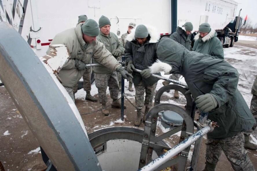 Col. Andrew Kovich, commander of the 91st Maintenance Group, gives members
of the Nuclear Oversight Board a tour of the missile maintenance trainer on
Minot Air Force Base, N.D., Feb. 19, 2015. In addition to participating in
the NOB, senior leaders got a first-hand look at the Minot missile fields
and flightline. (U.S. Air Force photo/Airman 1st Class Sahara L. Fales)