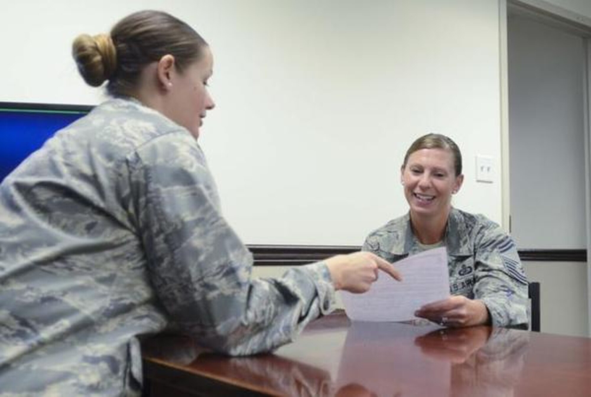Senior Master Sgt. Melisa Bumgardner (right), 62nd Comptroller Squadron superintendent, reviews a financial document with Maj. Jennifer Smith, 62nd CPTS commander. Under her leadership, more than 20 Airmen were recognized for outstanding performance, winning both McChord Field “Airman of the Quarter” and Air Mobility Command “Airman of the Quarter” awards. (Northwest Guardian/Senior Airman Jacob Jimenez)