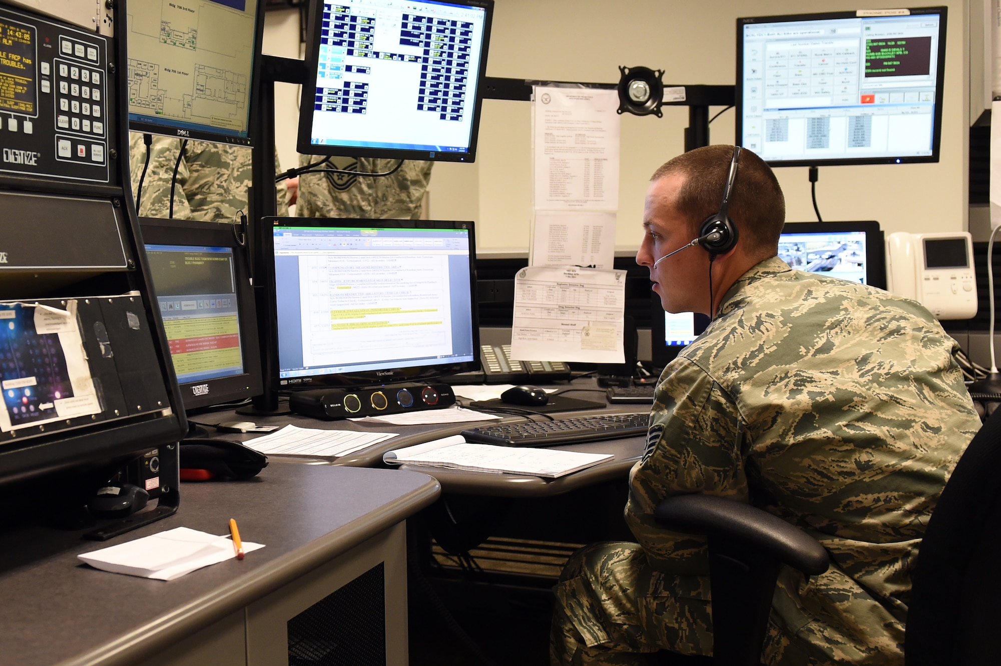 Staff Sgt. Adam Hughes, 460th Security Forces Squadron Base Defense Operations Center controller, monitors base security Feb. 19, 2015, during the new BDOC ribbon cutting ceremony on Buckley Air Force Base, Colo. The BDOC ribbon cutting ceremony took place to recognize the new BDOC being opened in the 460th SFS building. (U.S. Air Force Photo by Airman 1st Class Emily E. Amyotte/Released)