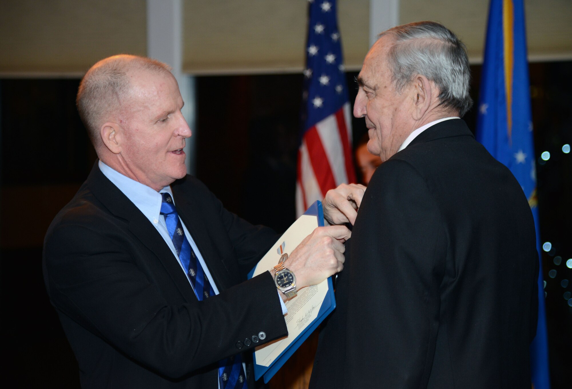 Lt. Gen. Stephen Wilson, left, Air Force Global Strike Command commander, pins on the Commanders Award for Public Service to Warren Wenz, a longtime member of the Air Force Global Strike Command Civic Leader Program Feb. 18 at the Meadowlark Country Club in Great Falls, Mont. Wenz received the award for his long and dedicated commitment to the Air Force and the Great Falls area. (U.S. Air Force photo/ Airman 1st Class Dillon Johnston)