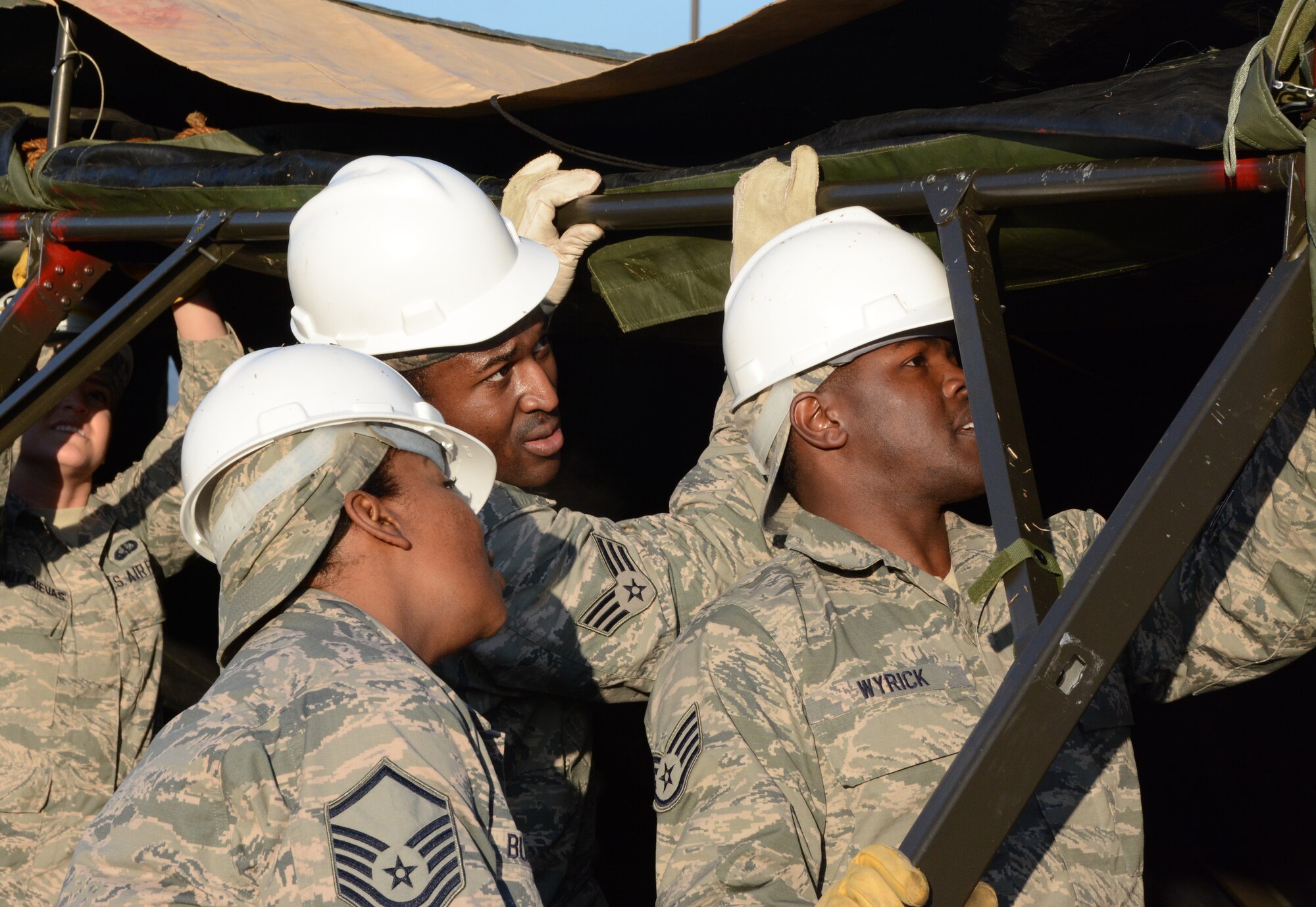 NAVAL AIR STATION FORT WORTH JOINT RESERVE BASE, Texas - Master Sgt. Treka Bunkley, 301st Services Flight lodging noncommissioned officer-in-charge, inspects the tent joint set by Senior Airman Robert Hughes, 301 SVF sustainment services journeyman, and Staff Sgt. Brandon Wyrick, 301 SVF food operations craftsman, Feb. 7 here while competing for their second Air Force Reserve Command Hennessy trophy. Ten Services Airmen formed a single pallet expeditionary kitchen (SPEK) then served 165 Airmen lunch. (U.S. Air Force photo by Staff Sgt. Samantha Mathison)