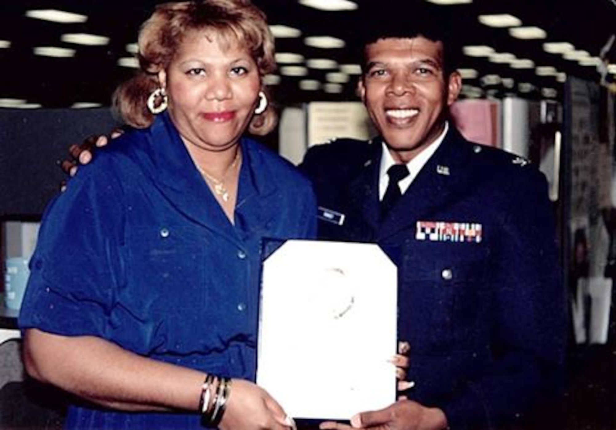Col. Joseph C. Ramsey presents a certificate to Margaretta “Gretta” Burroughs in an undated photo. Ramsey was the first and only African-American commander at the Air Reserve Personnel Center when it was previously located at the former Lowry Air Force Base, Colorado. He served as the 21st ARPC commander from May 16, 1987 until Aug. 23, 1991. (U.S. Air Force courtesy photo)