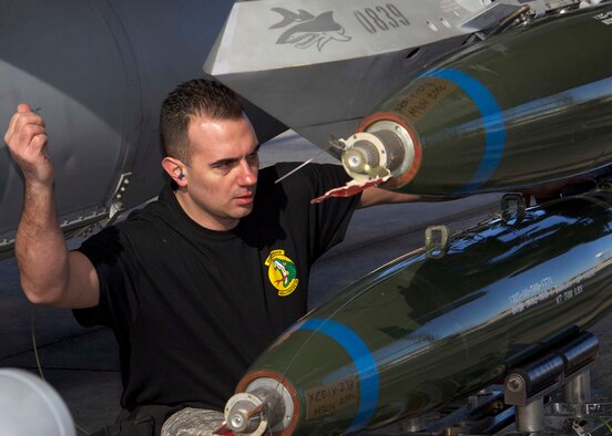HOMESTEAD AIR RESERVE BASE, Fla. - Tech. Sgt. Bryan Wicker, weapons load crew member from the 419th Fighter Wing, Hill Air Force Base, Utah, directs his teammate who’s driving the jammer holding the bomb so that it can be aligned correctly during the 10th Air Force Load Competition Championship at Homestead Air Reserve Base, Fla., Feb. 19. Once the bomb is lined up and in place, Wicker secures it in place. (U.S. Air Force photo by Staff Sgt. Jeremy Roman)