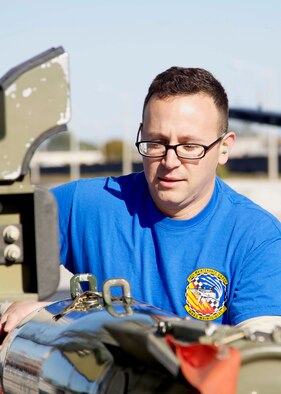 HOMESTEAD AIR RESERVE BASE, Fla. - Staff Sgt. Michael Kierszman, weapons load crew member from the 482nd Fighter Wing, Homestead Air Reserve Base, Fla., guides a bomb into place before securing it during the 10th Air Force Load Competition Championship here Feb. 19. Weapons loaders work in teams of three and are evaluated on a monthly basis to ensure readiness and proficiency. (U.S. Air Force photo by Senior Airman Jaimi L. Upthegrove)