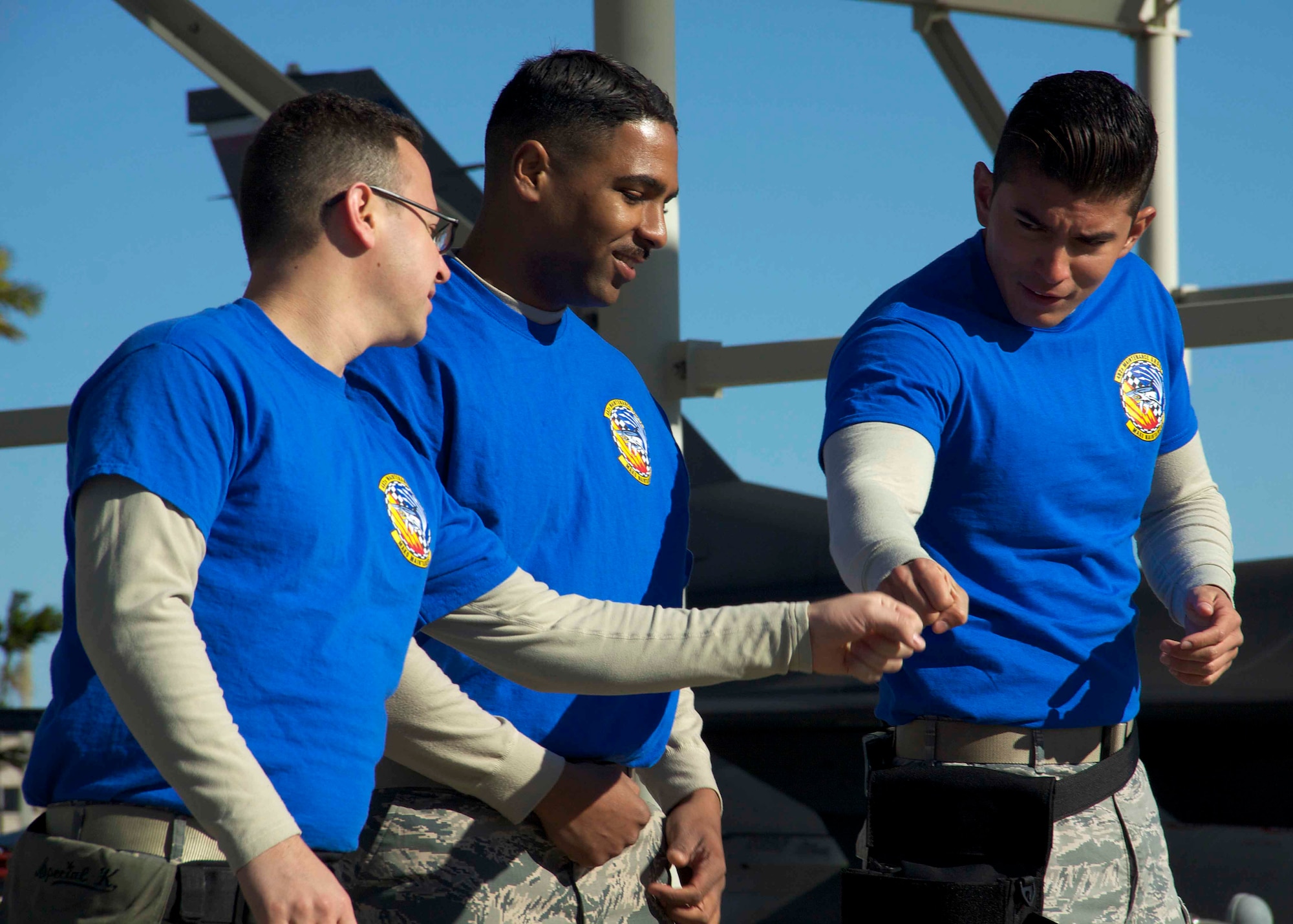 HOMESTEAD AIR RESERVE BASE, Fla. - Staff Sgt. Michael Kierszman, Staff Sgt. Adrian Perez-Inoa, and Senior Airman Esteban Reyes, weapons load crew members from the 482nd Fighter Wing here, fist-bump as they get ready to begin the munitions load portion of the 10th Air Force Load Competition Championship at Homestead Air Reserve Base, Florida, Feb. 19. Though the team did not win the championship, they represented the 482 FW well said Tech. Sgt. Branden Paddock, load standardization crew member for the 482nd. (U.S. Air Force photo by Senior Airman Jaimi L. Upthegrove)