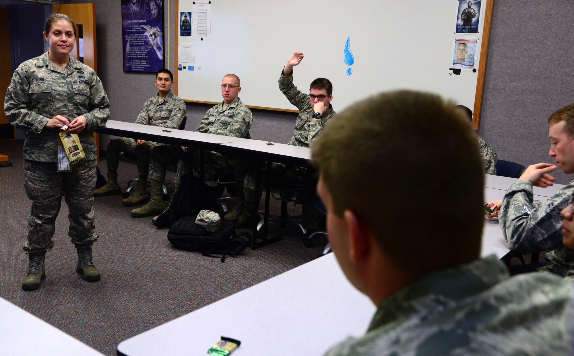 Tech. Sgt. April Horn, the 71st Judge Advocate Office NCO in-charge, answers legal questions during a First Term Airman Center briefing in the Professional Development Center, Feb. 11. Airmen arriving at their first duty station are required to attend FTAC. The program’s purpose is to reaffirm what Airmen learned during training and showcase what resources are available to them at their base. (U.S. Air Force photo/Senior Airman Frank Casciotta)