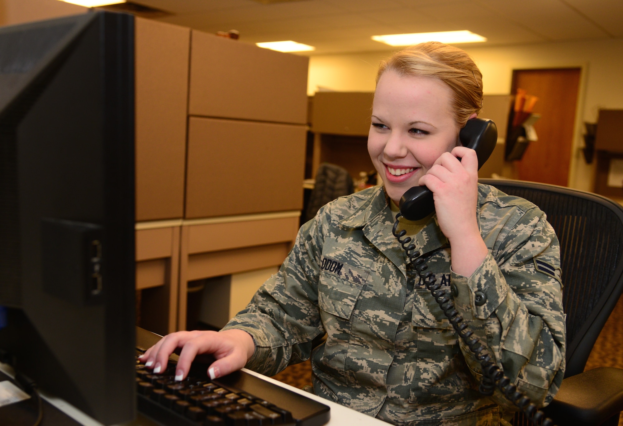 VANCE AIR FORCE BASE, Okla. – Airman 1st Class Faith Odom, a Elkville, Illinois, native and 71st Medical Support Squadron records technician, speaks with a customer Feb. 5 at the Vance Clinic. (U.S. Air Force photo / Senior Airman Frank Casciotta)