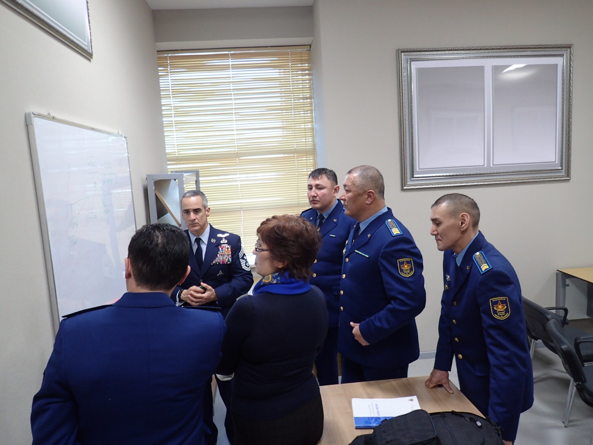 Command Chief Master Sergeant Ramon Colon-Lopez, U.S. Air Forces Central Command, receives a briefing with members of the Armed Forces of Kazakhstan at the country's National University of Defense. Colon-Lopez recently attended a symposium to discuss how the United States and Kazakhstan could use their bilateral relationship to further develop the selection and training of each country's noncommissioned officer corps. The symposium was the first to feature the senior enlisted personnel from multiple U.S. Central Command components as well as all major branches of the Kazakh military. 