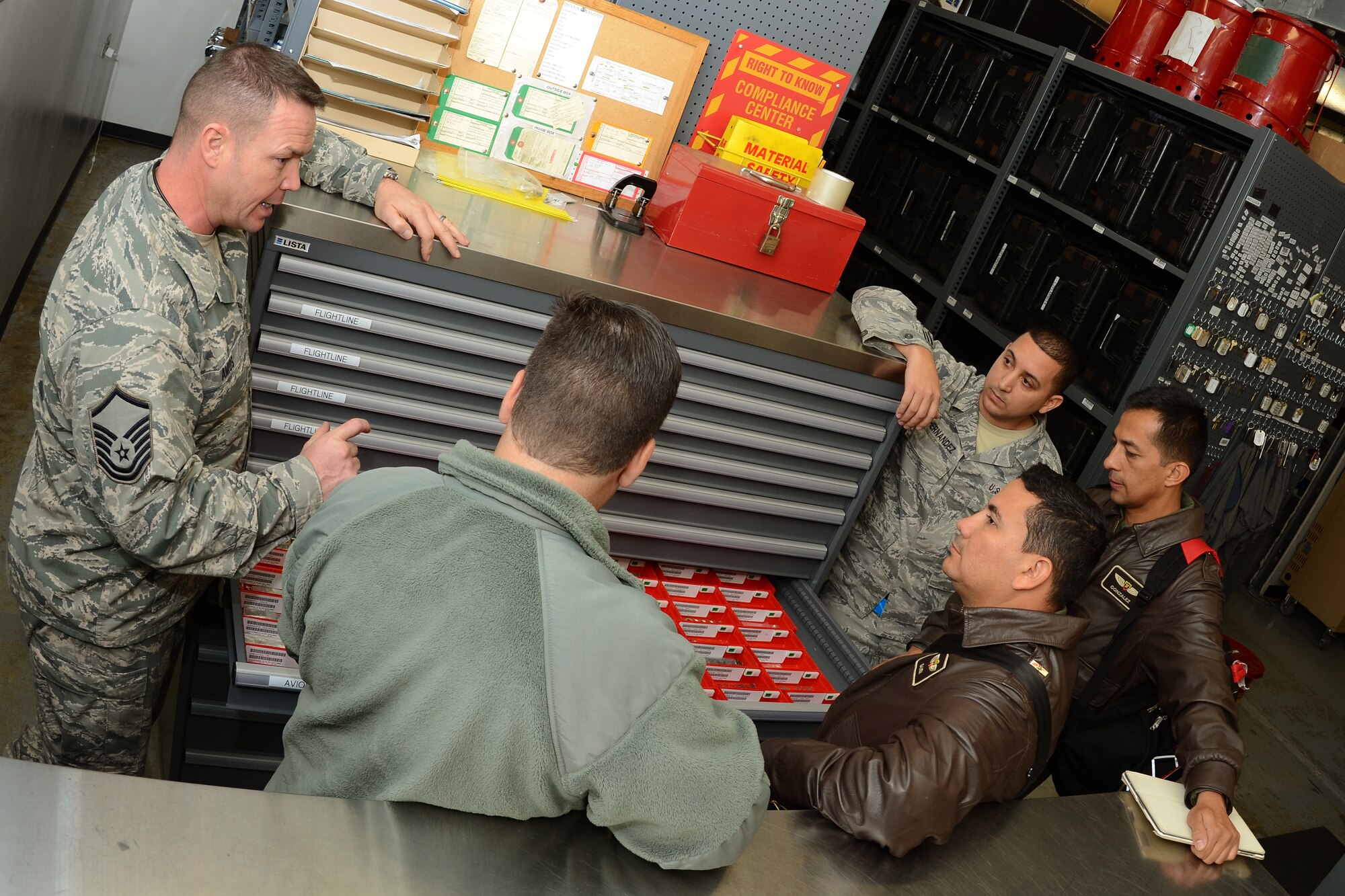 U.S. Air Force Master Sgt. Paul Amos (left), from the 169th Maintenance Squadron, provides hands-on training on tool room operations to Colombian Air Force maintenance officers Maj. Juan Gonzalez and Maj. Naily Ganem during a State Partnership Program (SPP) visit at McEntire Joint National Guard Base, S.C., Feb. 19, 2015. The Colombian Air Force sent a delegation of experts as a part of a three-day Key Leader Engagement and Subject Matter Expert exchange sharing information on flying and maintenance operations at McEntire JNGB and fostering relationships between the militaries. (U.S. Air National Guard photo by Senior Master Sgt. Edward Snyder/Released)