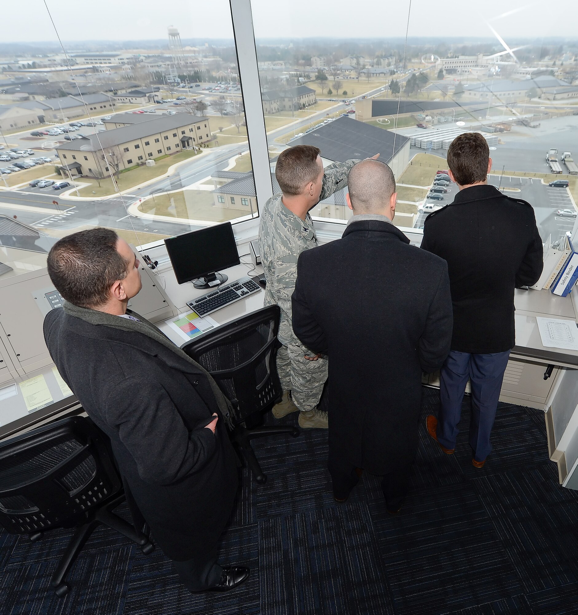Col. Kevin Gordon, 436th Airlift Wing vice commander, points out major landmarks to staff members from Sen. Chris Coons??? office from inside the air traffic control tower during a tour Feb. 9, 2015, at Dover Air Force Base, Del. During their visit, the staff members toured the aircraft, major organizations and facilities to better understand Dover AFB capabilities. (U.S. Air Force photo/Greg L. Davis)