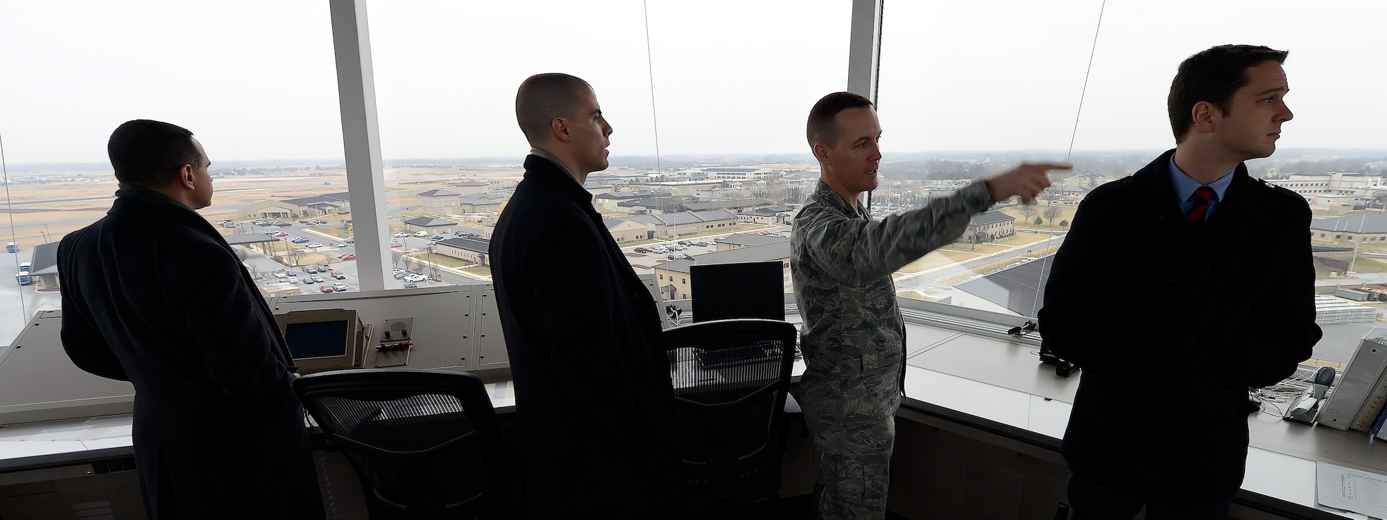 Col. Kevin Gordon, 436th Airlift Wing vice commander, points out major landmarks to staff members from Sen. Chris Coons??? office from inside the air traffic control tower during a tour Feb. 9, 2015, at Dover Air Force Base, Del. During their visit, the staff members toured the aircraft, major organizations and facilities to better understand Team Dover???s capabilities. (U.S. Air Force photo/Greg L. Davis)