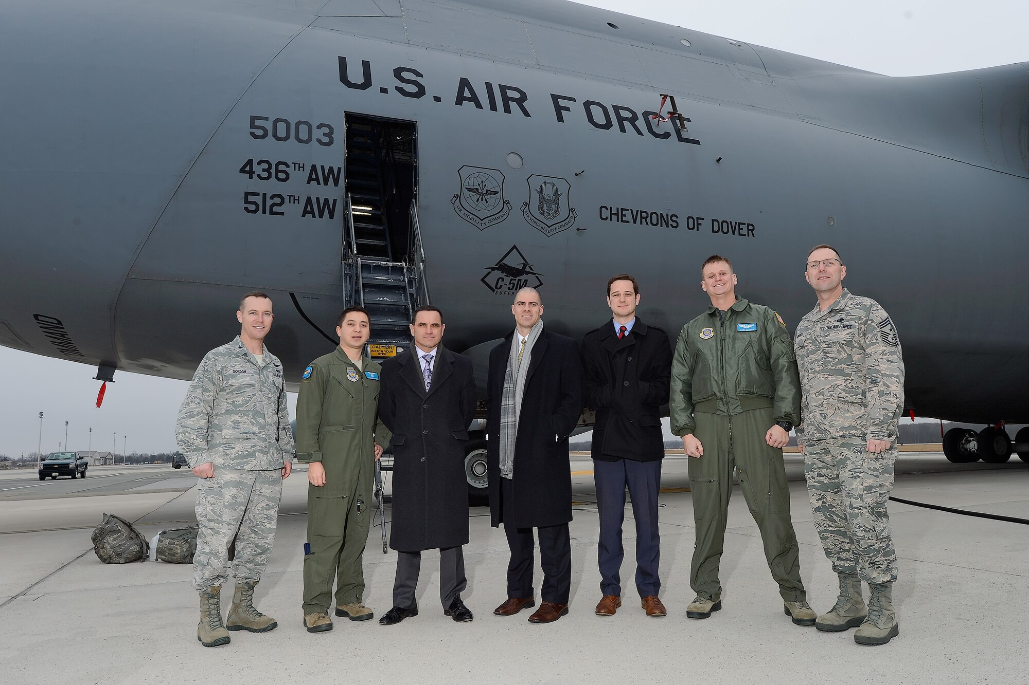 A group photo in front of C-5M Super Galaxy, 'Chevrons of Dover,' of the 436th Airlift Wing Feb. 9, 2015, at Dover Air Force Base, Del. Shown from left to right are: Col. Kevin Gordon, 436th Airlift Wing vice commander, Staff Sgt. Jon Meyers, 9th Airlift Squadron C-5M flight engineer, Tom Mancinelli, Foreign Relations/Defense Legislative Assistant, Mike McGowan, New Castle County director, Ryan Doherty, Legislative Fellow, Capt. Marc Beckius, 9th AS C-5M pilot, and Chief Master Sgt. Stanley Cadell, 436th AW command chief. Sen. Chris Coons??? staff toured aircraft along with major organizations and facilities at Dover AFB to better understand the mission and capabilities. (U.S. Air Force photo/Greg L. Davis)