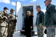 Secretary of the Air Force Deborah Lee James, center, and Lt. Gen. Stephen Wilson, commander of Air Force Global Strike Command, far right, speak with Senior Airmen Jordan Arrendondo and Benny Dorman, 741st Missile Security Forces Squadron members, about the new Model Defender gear provided by AFGSC’s Force Improvement Program Feb. 19. James and Wilson visited Malmstrom to discuss the progress of FIP over the past year. (U.S. Air Force photo/Staff Sgt. Delia Marchick) 