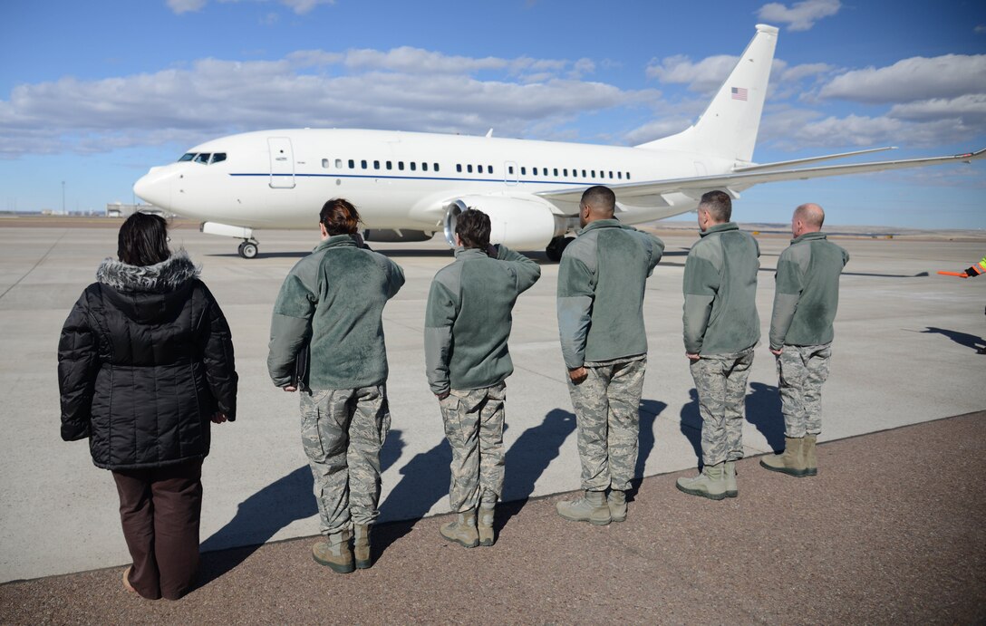 Members of a greeting party salute as Secretary of the Air Force Deborah Lee James arrives Feb. 19 in Great Falls, Mont. James traveled to Great Falls to speak with Team Malmstrom leaders and Airmen about the Force Improvement Program, the nuclear triad and the nuclear mission on Malmstrom Air Force Base, Mont. (U.S. Air Force photo/Airman 1st Class Dillon Johnston)