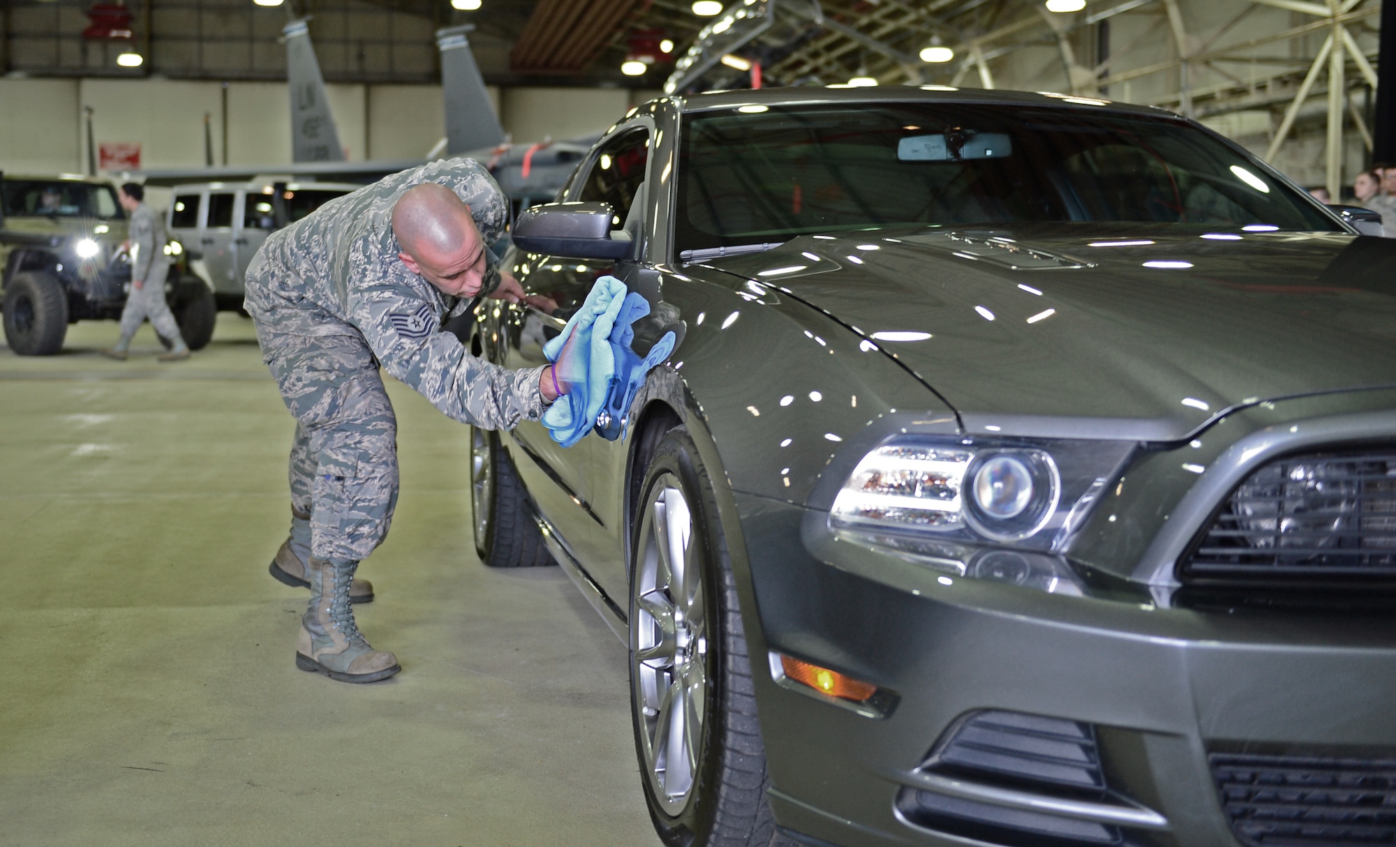 Tech. Sgt. Ryan Forsse, 492nd Aircraft Maintenance Unit flightline expeditor, does a final wipe-down of his 2013 Mustang GT before the BBC Top Gear Magazine photo shoot at Royal Air Force Lakenheath, England, Feb. 19, 2015. A feature about Liberty Airmen and their cars will be published in the April 2015 issue. (U.S. Air Force photo by Airman 1st Class Erin R. Babis/Released)