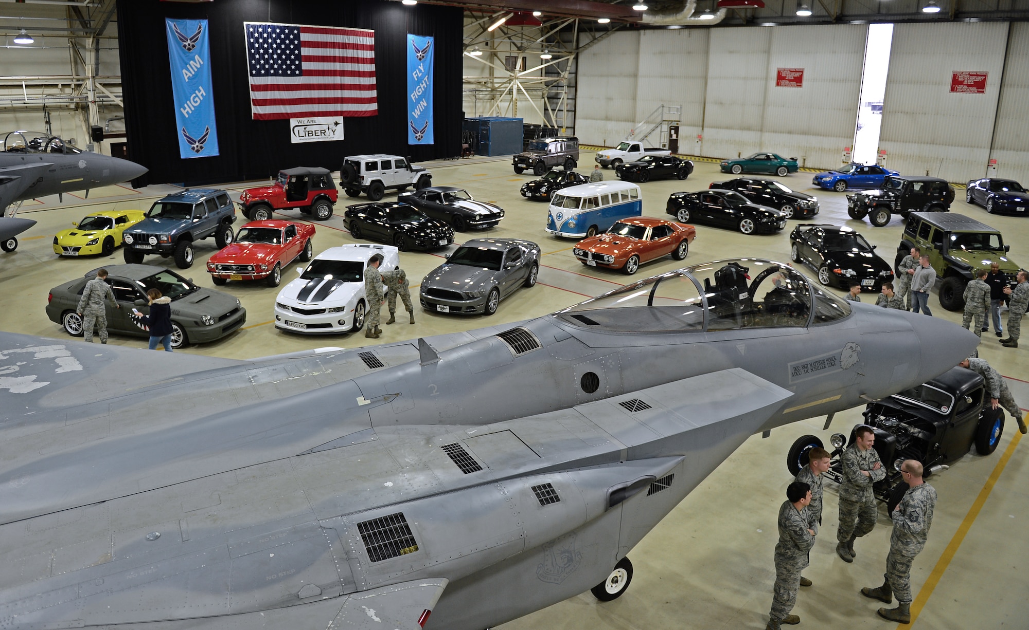 Liberty Amirmen’s cars are showcased with an F15-C Eagle for a media visit with Top Gear Magazine at Royal Air Force Lakenheath, England, Feb. 19, 2015. Media visited the 48th Fighter Wing to put together a feature about Liberty Airmen and their cars. (U.S. Air Force photo by Airman 1st Class Erin R. Babis/Released)