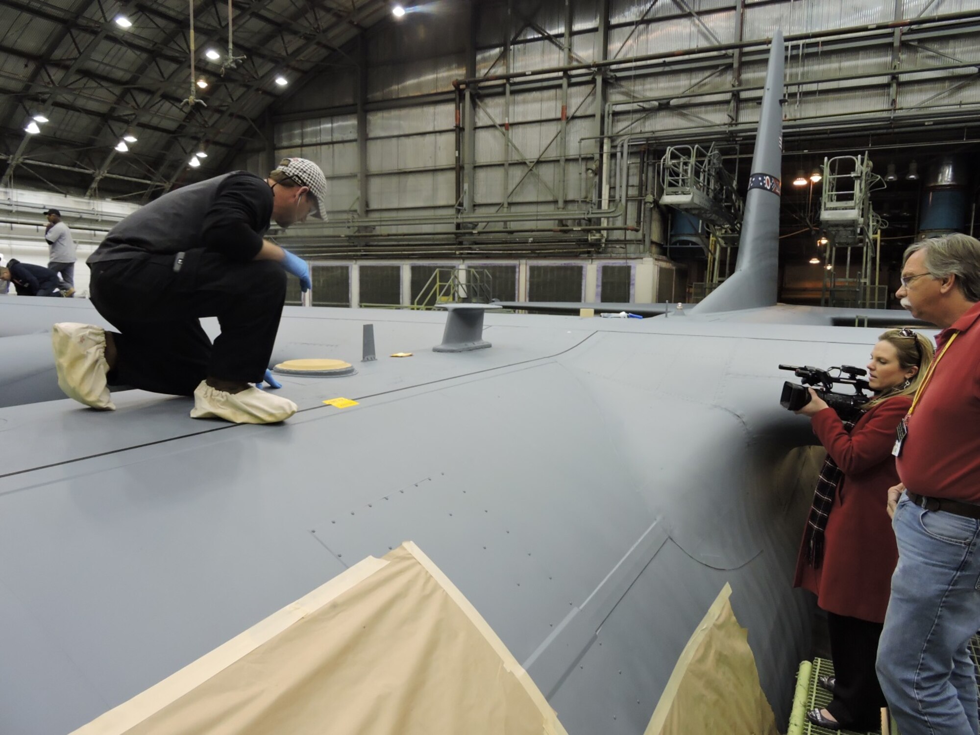 Timothy Davis (L), C-130 Paint Shop journeyman, displays one of the numerous markings and insignia that are applied over the topcoat to fully detail an aircraft. The 402nd AMXSS Aircraft paint/de-paint process will be featured on 13WMAZ's "Behind the Lines" segment airing Feb. 26 on the 6 p.m. Eyewitness News. (U.S. Air Force photo by Roland Leach) 




