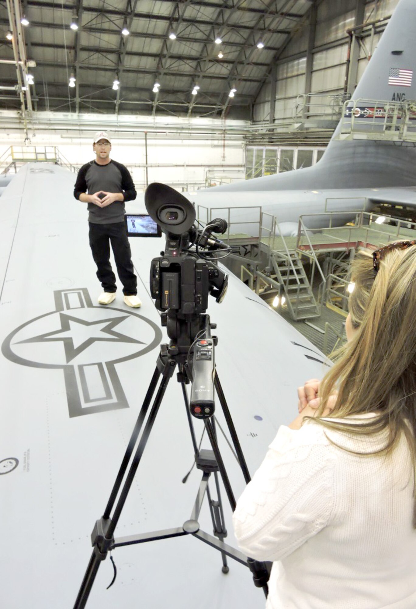 Timothy Davis, C-130 Paint Shop journeyman, explains what it takes to make a C-130 Hercules look brand new. The 402nd AMXSS Aircraft paint/de-paint process will be featured on 13WMAZ's "Behind the Lines" segment airing Feb. 26 on the 6 p.m. newscast. (U.S. Air Force photo by Roland Leach) 
