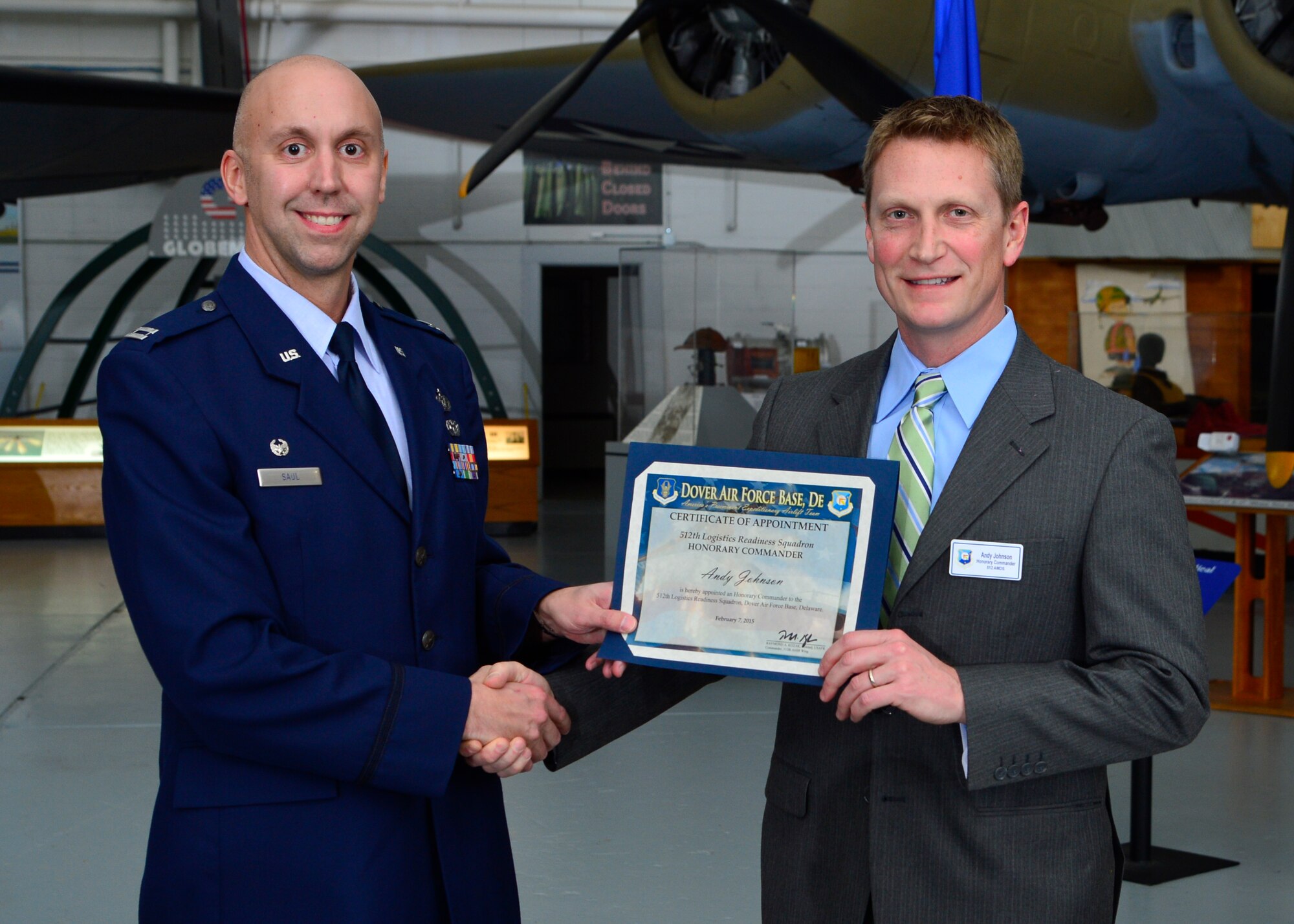 Capt. Brian Saul, 512th Logistics Readiness Squadron commander, presents a certificate of induction to Andrew Johnson, Dentsply International LD Caulk Division director of operations, as part of the Team Dover Honorary Commander Induction Ceremony Feb. 7, 2015, at the Air Mobility Command Museum. The Honorary Commander Program began in 1992 at Dover Air Force Base, Del.,to foster relationships between civic and military leaders. (U.S. Air Force photo/Airman 1st Class William Johnson)
