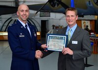 Capt. Brian Saul, 512th Logistics Readiness Squadron commander, presents a certificate of induction to Andrew Johnson, Dentsply International LD Caulk Division director of operations, as part of the Team Dover Honorary Commander Induction Ceremony Feb. 7, 2015, at the Air Mobility Command Museum. The Honorary Commander Program began in 1992 at Dover Air Force Base, Del.,to foster relationships between civic and military leaders. (U.S. Air Force photo/Airman 1st Class William Johnson)
