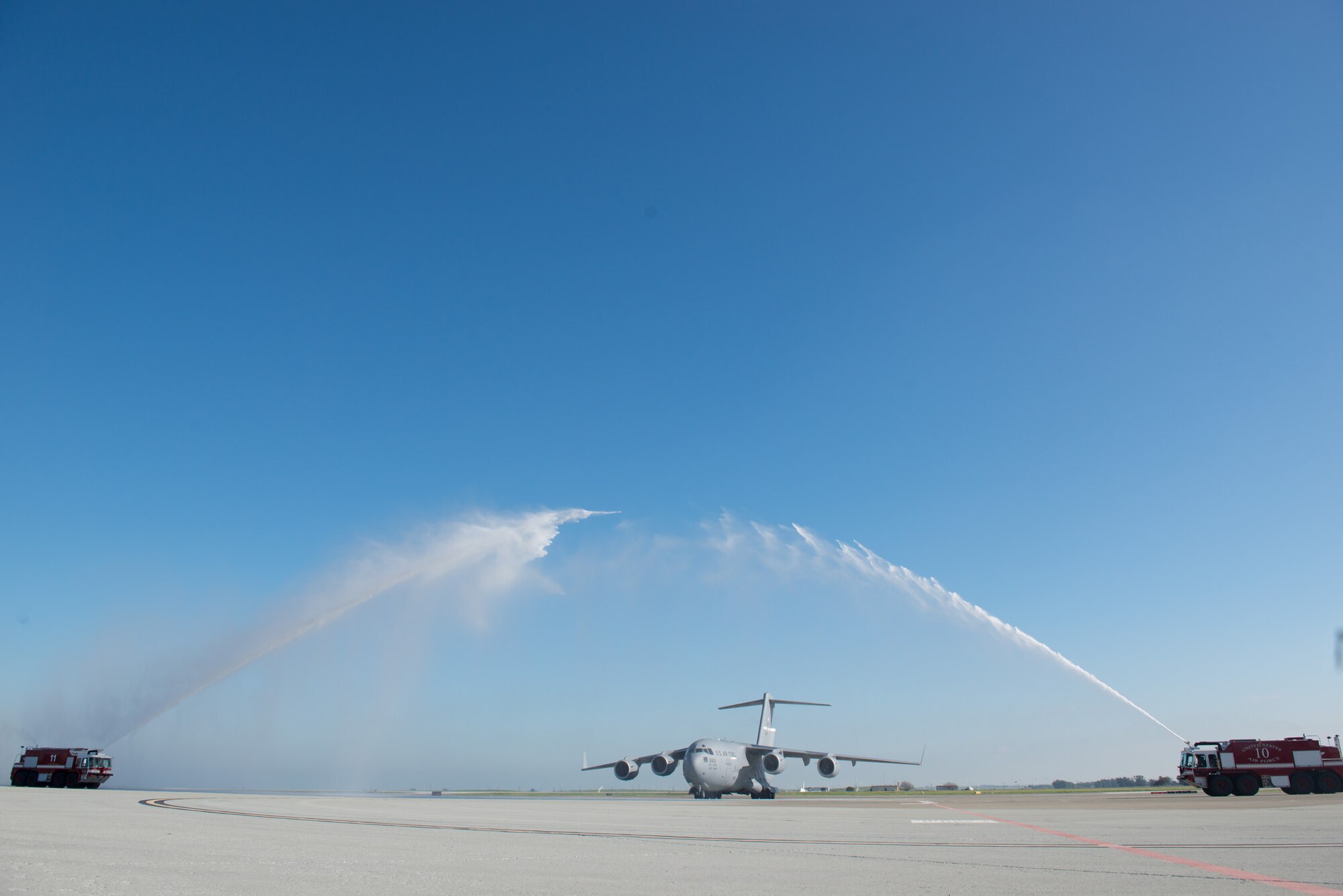 Col. Corey Martin, 60th Air Mobility Wing commander, received a warm, but wet welcome from his wife and children upon completing his "fini flight" at Travis AFB, Calif., Feb. 17, 2015. Martin has been the wing commander since August 2014, and will soon begin his new assignment in South Korea. (U.S. Air Force photo/Ken Wright)