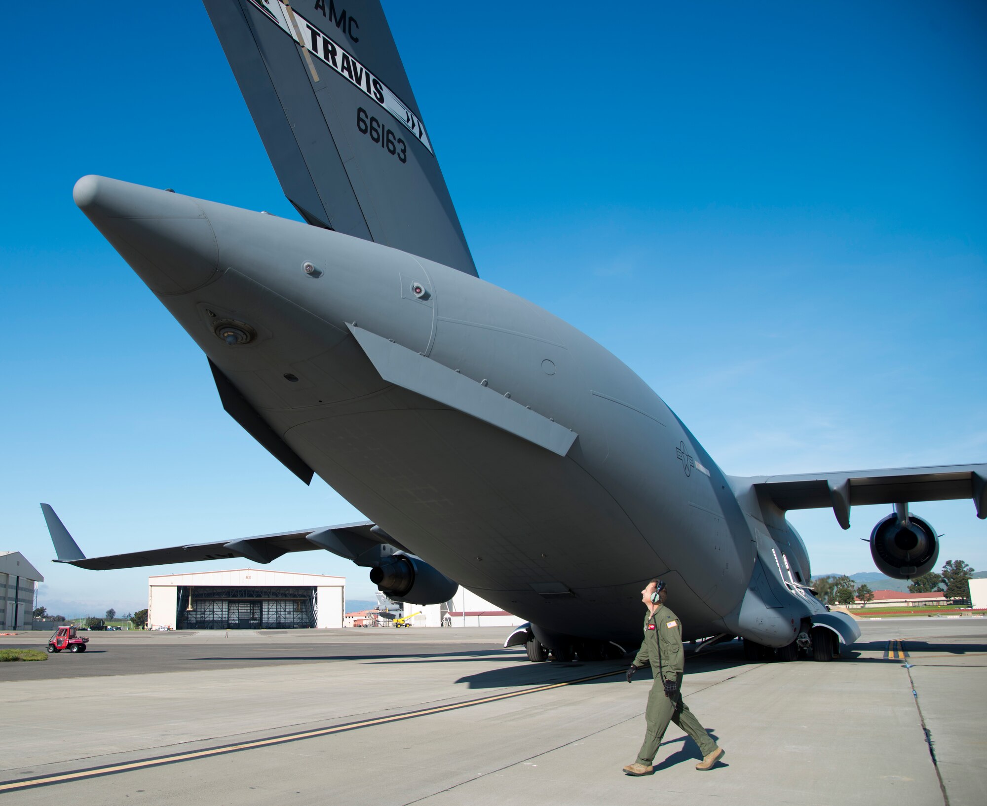 Col. Corey Martin, 60th Air Mobility Wing commander, walks around a C-17 Globemaster III during a pre-flight inspection before his fini-flight Feb. 17, 2015. (U.S. Air Force photo by Senior Airman Nicole Leidholm)