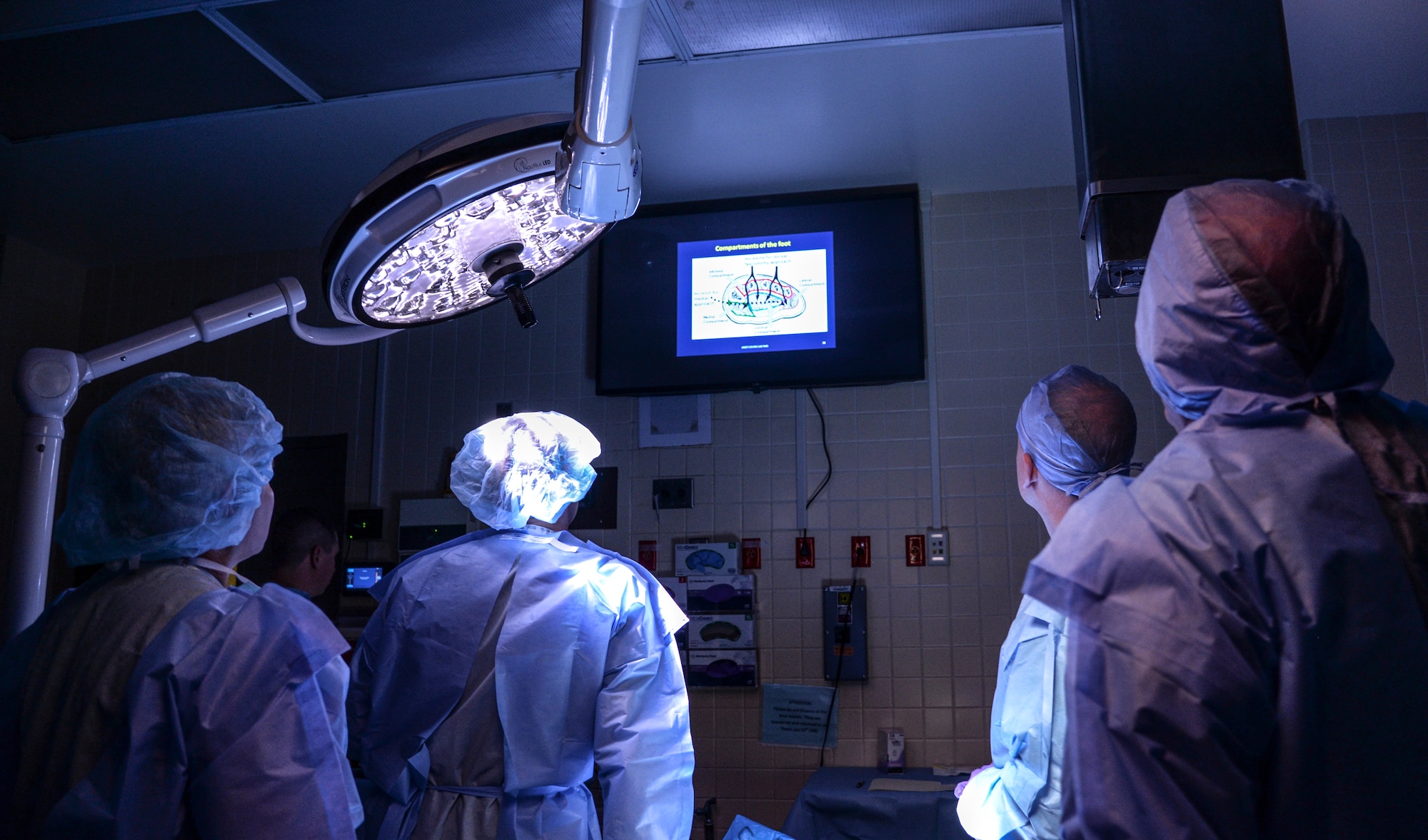 Surgeons in the Emergency War Surgery Course at Wilford Hall Ambulatory Surgical Center on Joint Base San Antonio-Lackland, Texas, listen to the advanced surgical skills for exposure in trauma lesson, Feb. 11, 2015. The Emergency War Surgery Course has been conducted at Wilford Hall since it was established back in 2004. (U.S. Air Force photo/Staff Sgt. Michael Ellis)