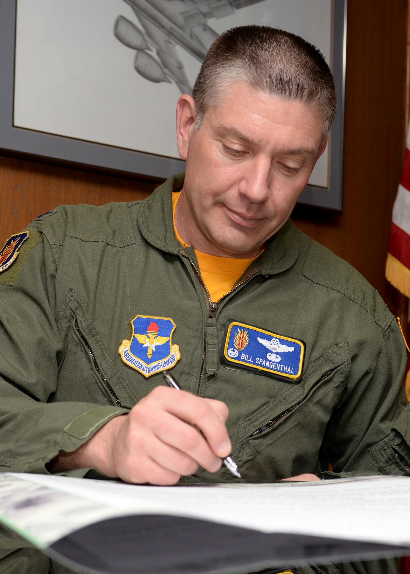ALTUS AIR FORCE BASE, Okla. – U.S. Air Force Col. Bill Spangenthal, 97th Air Mobility Wing commander, signs a proclamation inside his office, Feb. 20, 2015. Spangenthal signed the proclamation in support of Military Saves Week, a Department of Defense-sponsored campaign for service members, their families and DoD civilians to learn about healthy financial decisions. (U.S. Air Force photo by Senior Airman Franklin R. Ramos/Released)