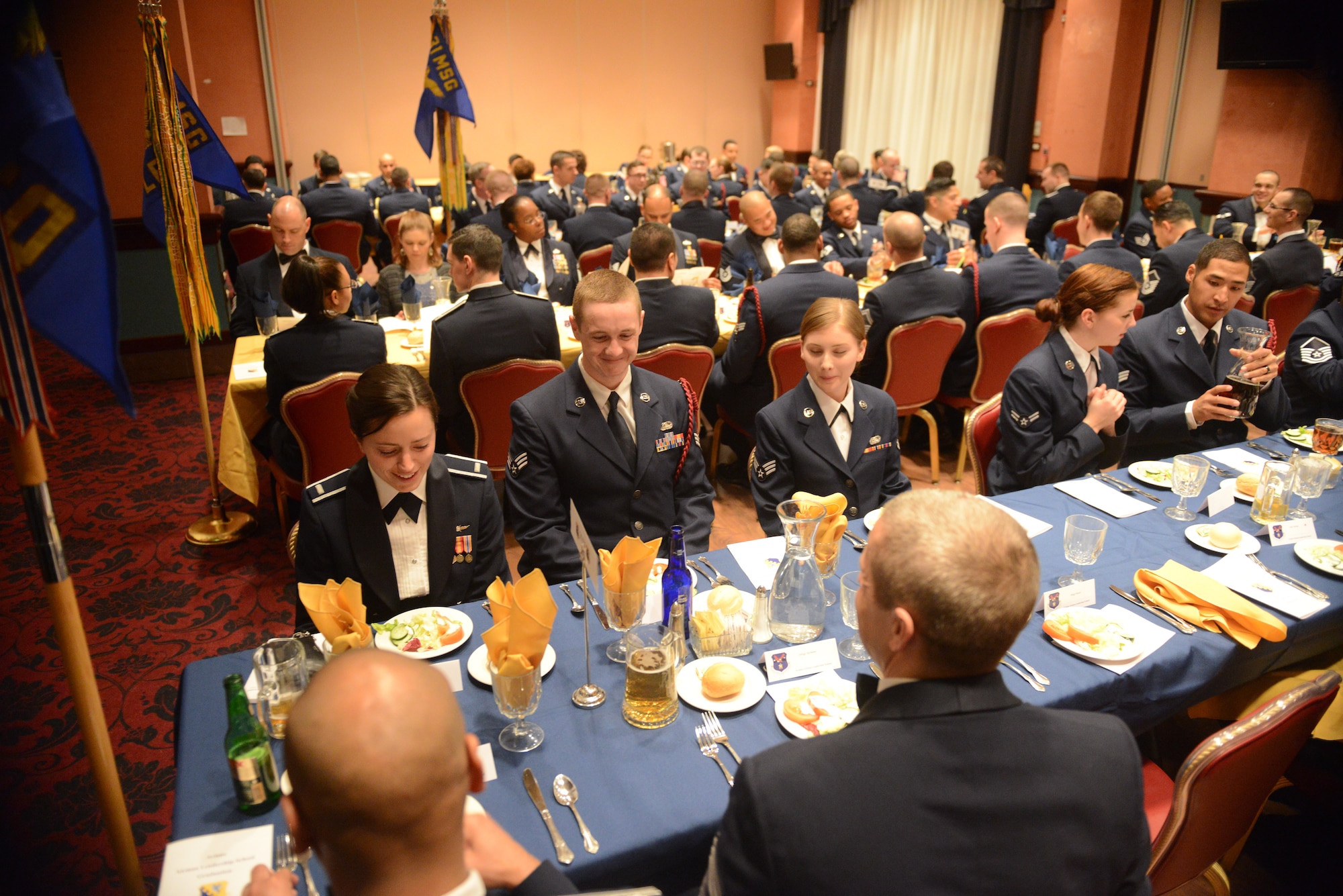 U.S. Air Force Airmen with the 31st Communications Squadron wait for the commencement of an Airman Leadership School graduation, Feb. 12, 2015, at Aviano Air Base, Italy.  ALS, a five-week course, helps develop front-line supervisors through several blocks of instruction. (U.S. Air Force photo by Staff Sgt. Evelyn Chavez/Released)