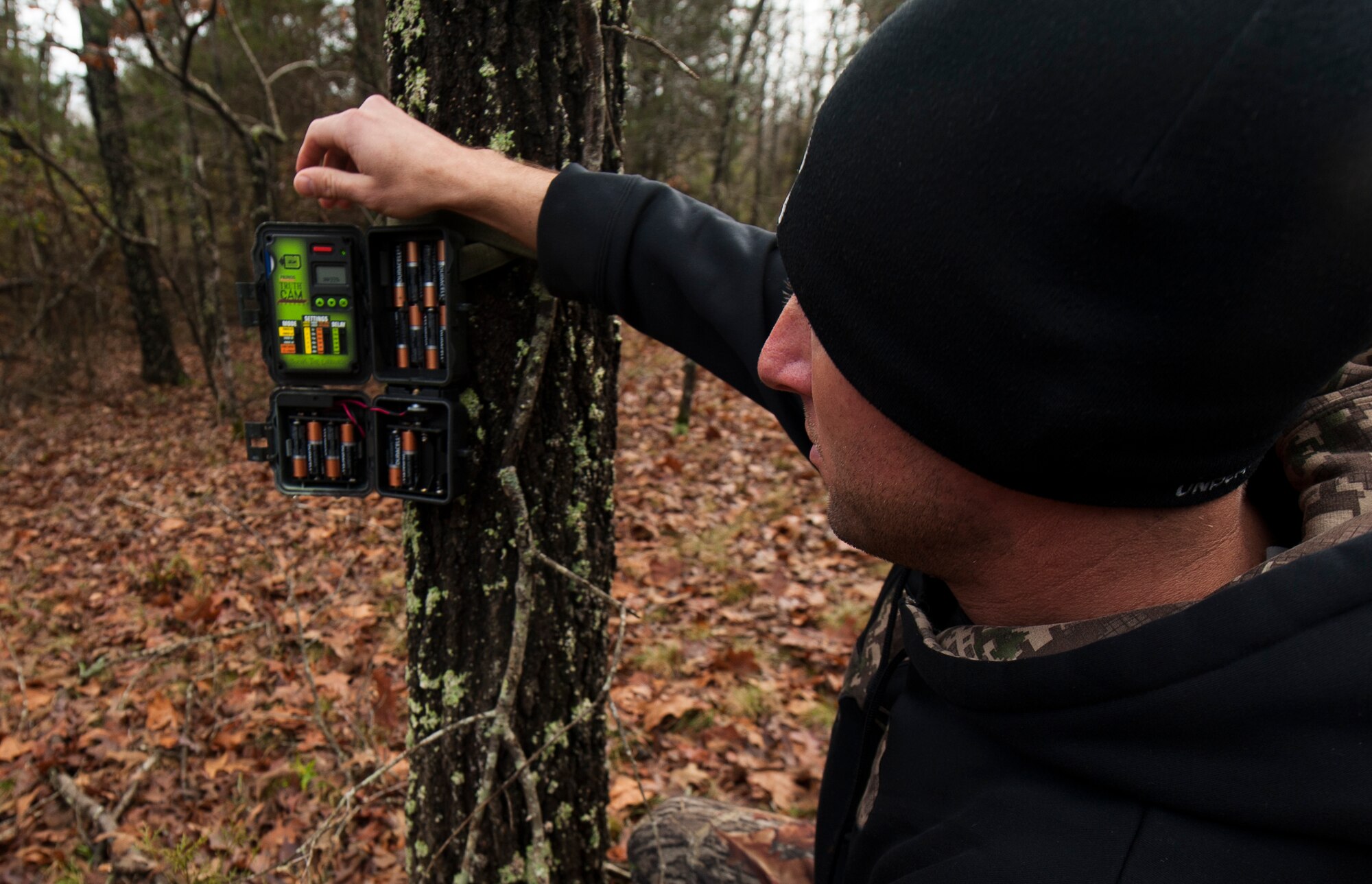Chaplain Capt. Matthew Spencer gathers footage from his trail camera Dec. 14, 2014, at Little Rock Air Force Base, Ark. Spencer watched many deer cross the path of his trail camera during the night hours, but was unsuccessful in harvesting any. (U.S. Air Force photo by Senior Airman Kaylee Clark) 