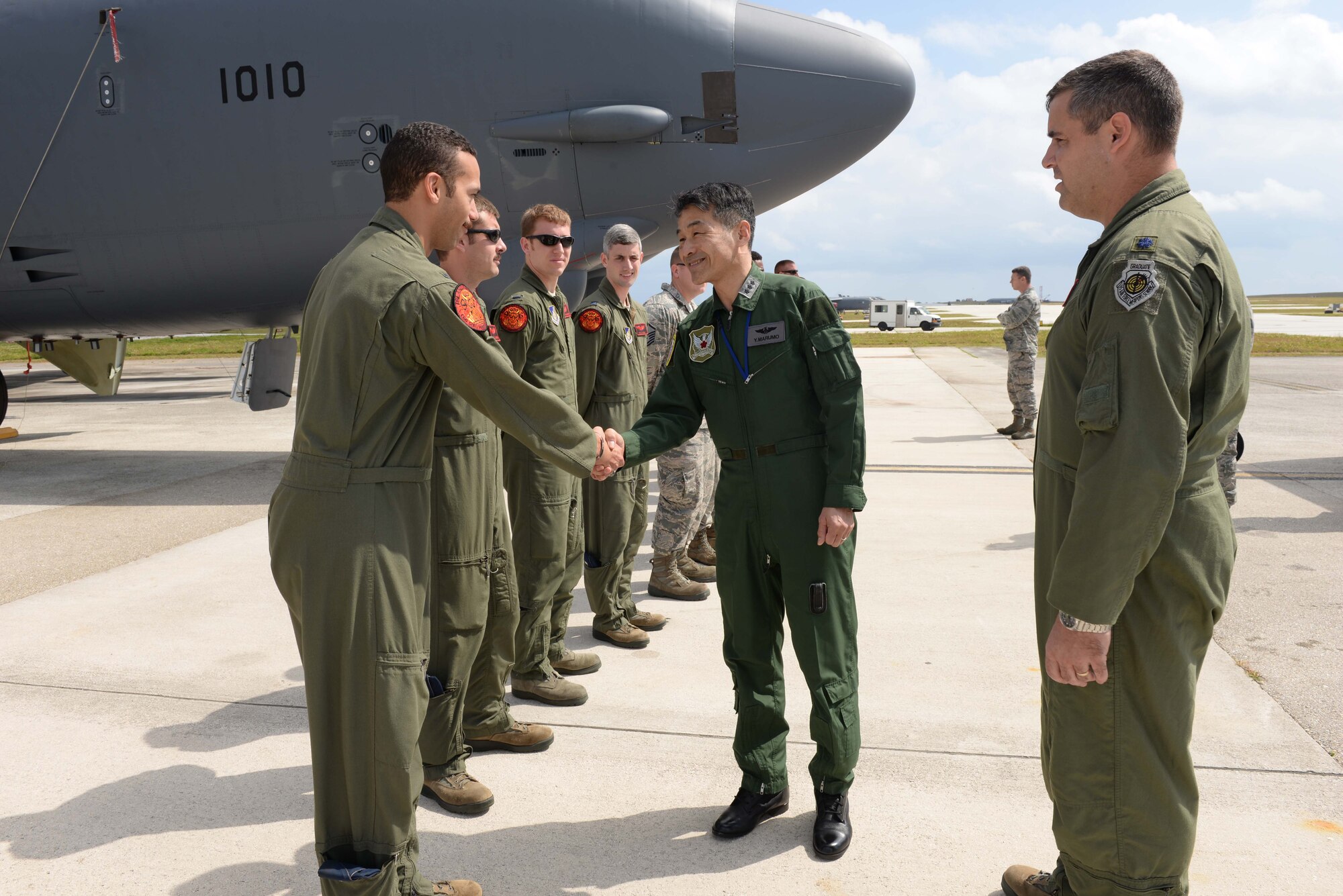 Lt. Gen. Yoshinari Marumo, Western Air Self- Defense Force commander, greets deployed Airmen from the 2nd Bomb Wing, Barksdale Air Force Base, LA, on the airfield during a tour of the base Feb. 19, 2015, at Andersen AFB, Guam. The Japan Air Self-Defense Force has eight Mitsubishi F-2s, six F-15 eagles, two E-2 Hawkeyes, 1 U-125, 2 Boeing KC-767s and one C-130 Hercules, deployed here in support of Cope North 2015, a multilateral training exercise which is a long-standing, multinational event designed to increase interoperability and improve combat readiness and develop a synergistic disaster response capability between the countries involved.  (U.S. Air Force photo by Senior Airman Cierra Presentado/Released)