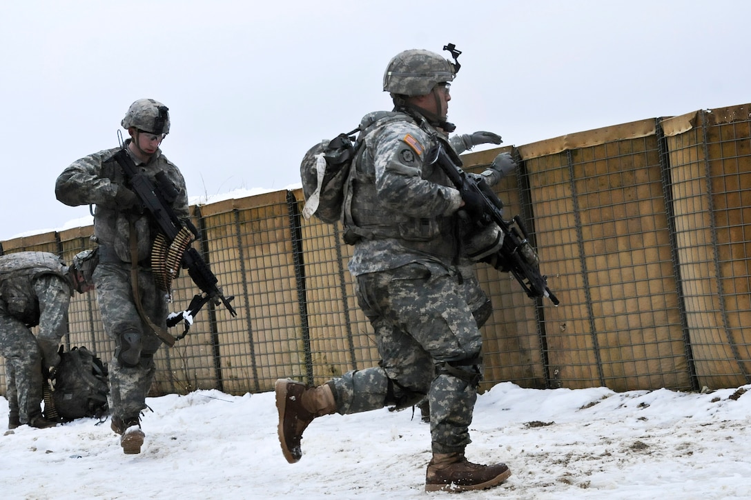 U.S. soldiers run to their next objective while participating in a troop live-fire exercise at the Grafenwoehr Training Area, Germany, Feb. 10, 2015.