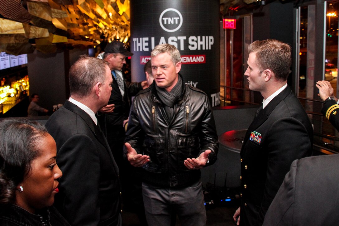 Eric Dane, center, star of TNT's "The Last Ship," talks with Navy Cmdr. Corey Barker, left, director of the Navy Office of Information East, and Navy photographer Lt. Matthew Stroup at the show's NBA All Star game party at Clyde Frazier's in New York City, Feb. 15, 2015.