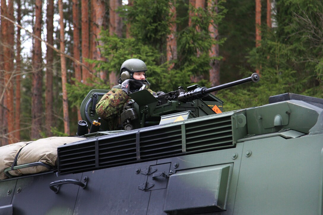 An Estonian soldier mans a machine gun on top of a tactical vehicle during a training exercise at the Tapa training grounds in Estonia, Feb. 11, 2015.
