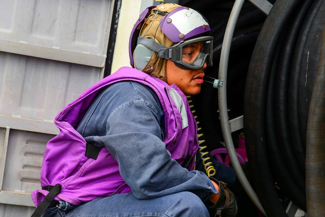 U.S. Navy Petty Officer 1st Class Demetrius Ward prepares to transfer fuel during flight quarters aboard the guided-missile destroyer USS Sterett in the U.S. 5th Fleet area of operations, Feb. 12, 2015. Ward is a gas turbine system technician mechanical.