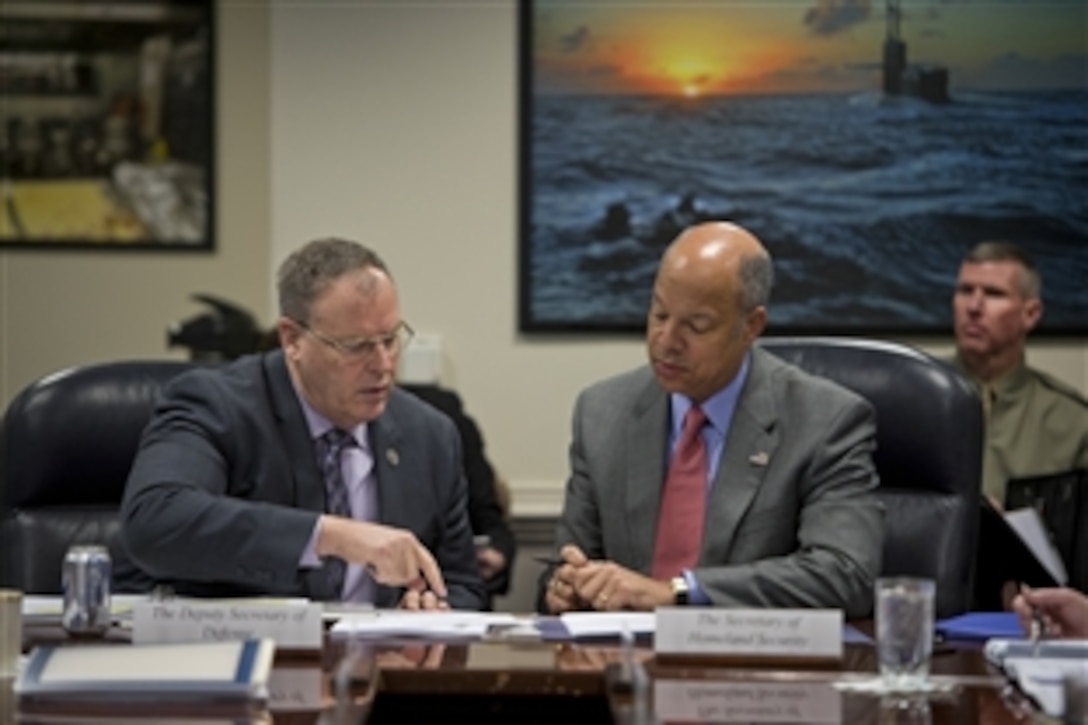 Deputy Defense Secretary Bob Work, left, speaks with Homeland Security Secretary Jeh Johnson during a Council of Governors meeting at the Pentagon, Feb. 20, 2015. 