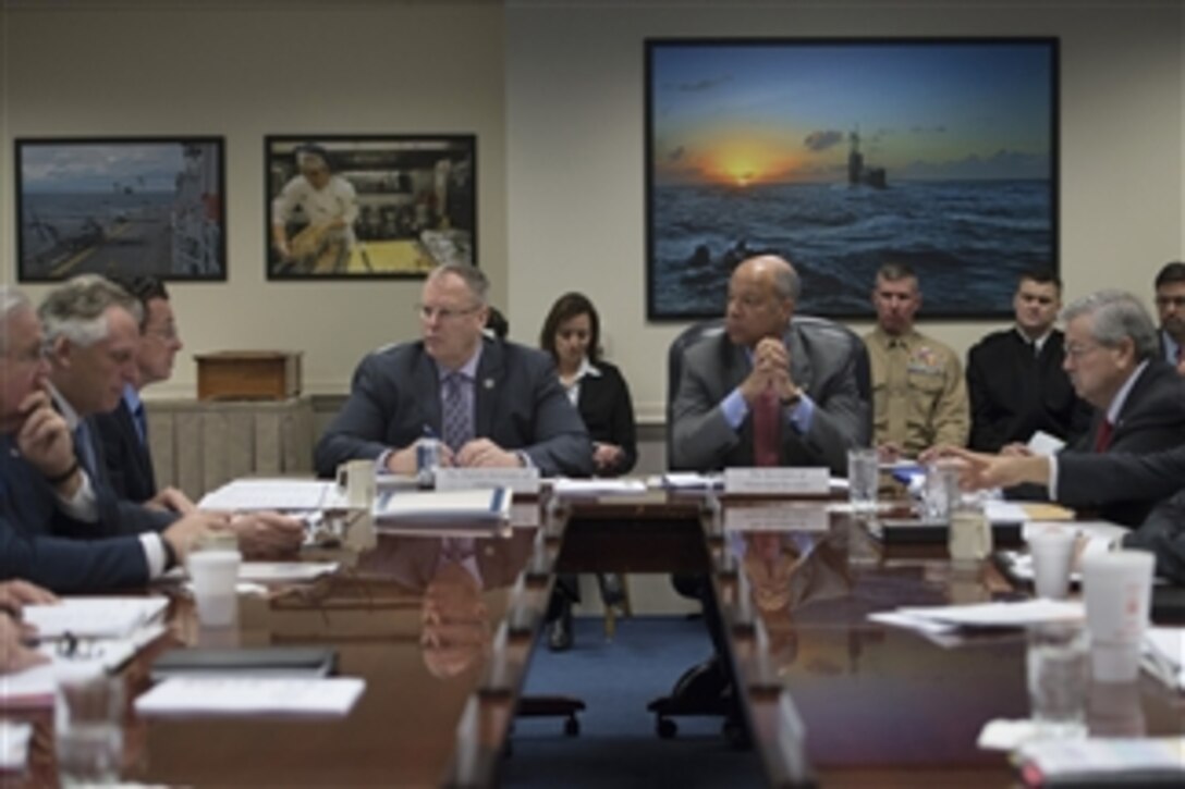 Deputy Defense Secretary Bob Work, center left, and Homeland Security Secretary Jeh Johnson, center right, listen during a Council of Governors meeting at the Pentagon, Feb. 20, 2015. 