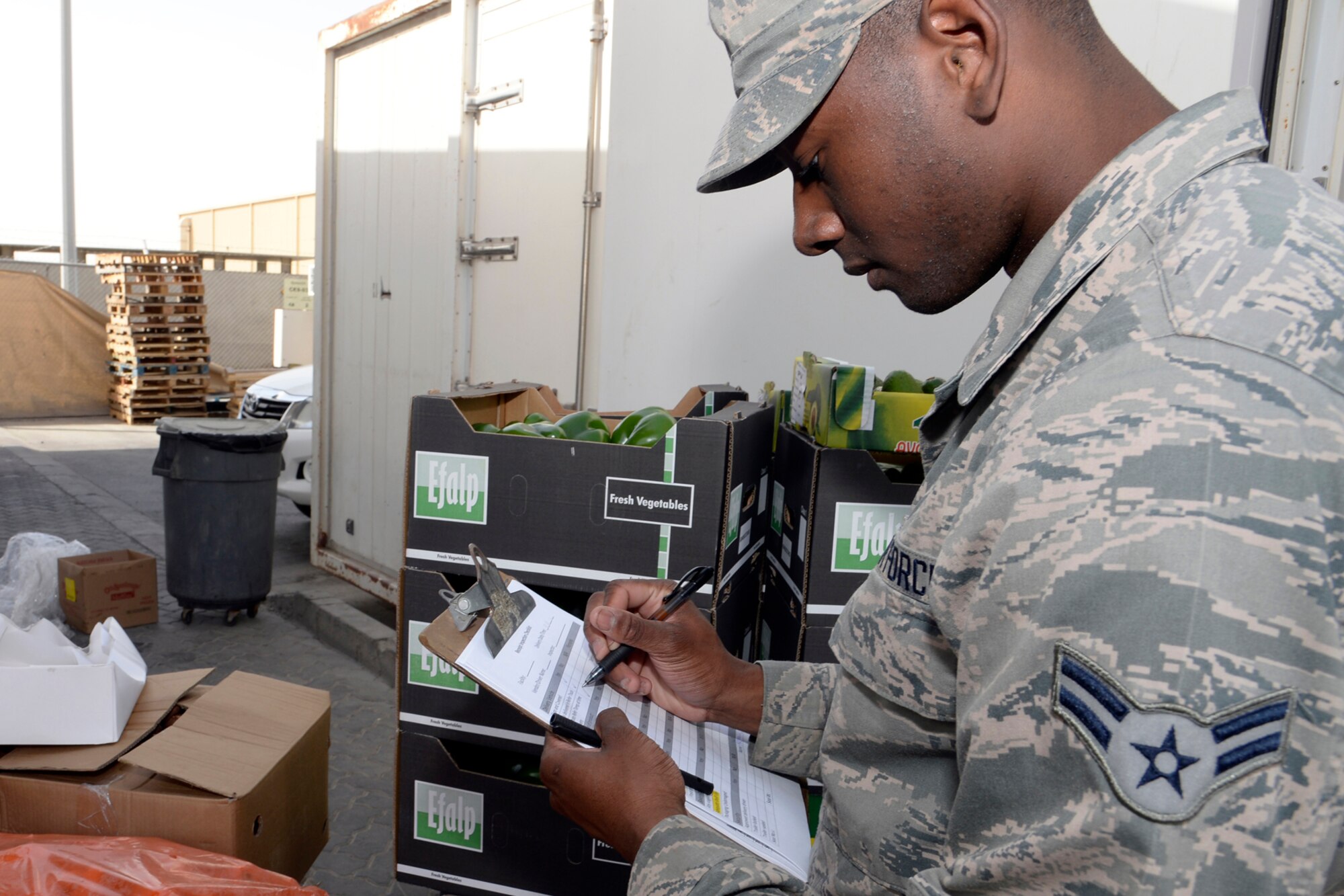 Airman 1st Class Nicolas, Oasis water distribution manager, completes his produce inspection checklist at an undisclosed location in Southwest Asia Feb. 17, 2015. The Oasis dining facility receives about three deliveries a week containing about $50K of consumable products. Nicolas is currently deployed from Mountain Home Air Force Base, Idaho and is a native of Huber Heights, Ohio. (U.S. Air Force photo/Tech. Sgt. Marie Brown)
