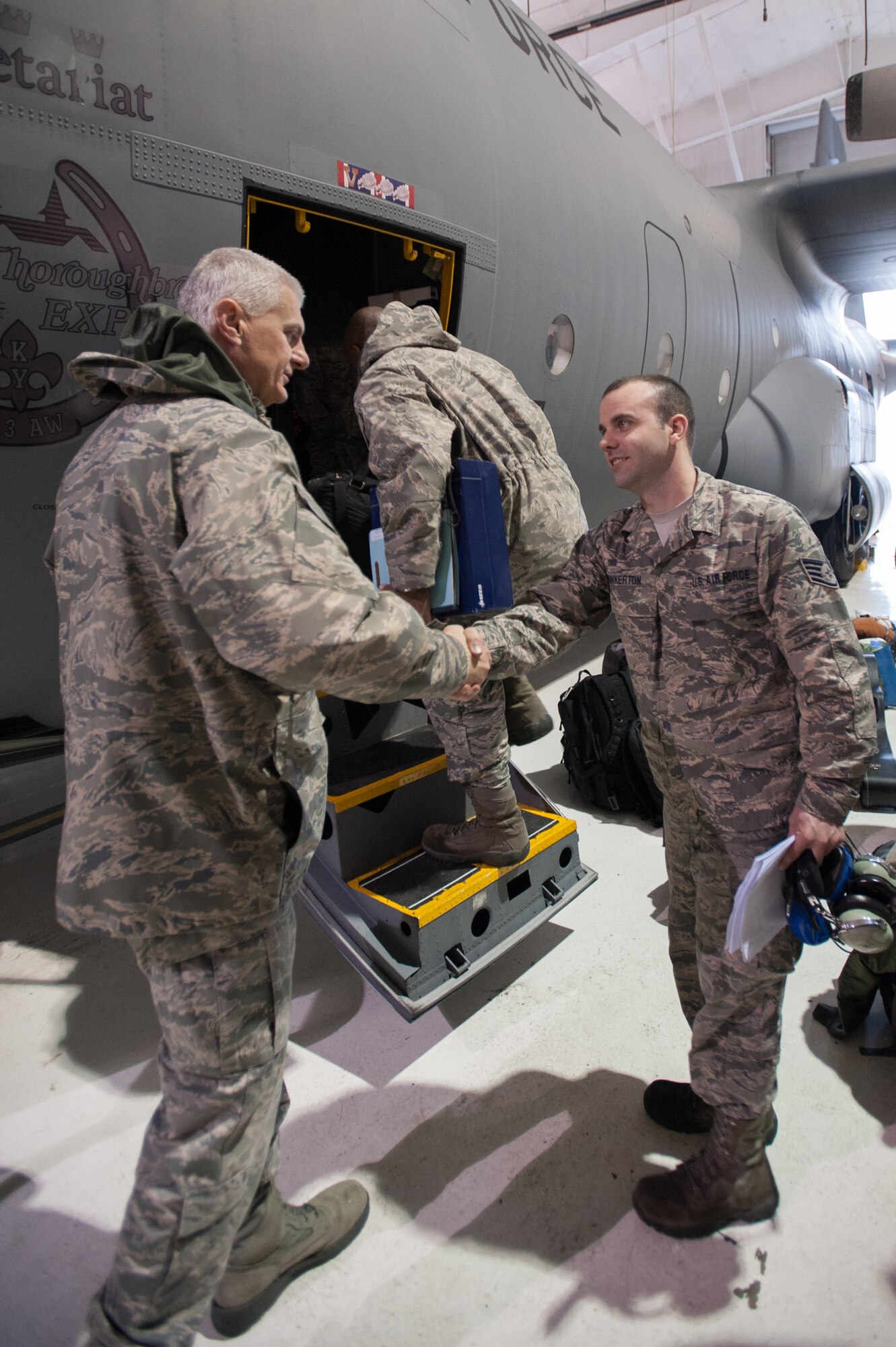 More than 35 members of the 123rd Airlift Wing board a C-130 Hercules aircraft at Kentucky Air National Guard Base in Louisville, Ky., Feb. 21, 2015, for a four-month deployment to the Persian Gulf region in support of Operation Freedom's Sentinel. The Airmen will fly troops and cargo across the U.S. Central Command Area of Responsibility, which includes the Persian Gulf, Northern Africa and Afghanistan. (U.S. Air National Guard photo by Maj. Dale Greer)